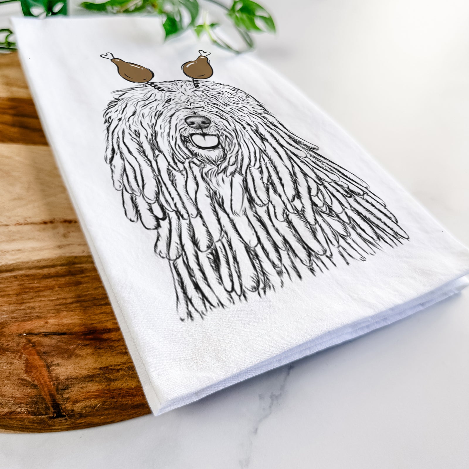 Hand-drawn sketch of Barry the Komondor with a Thanksgiving turkey headpiece on a tea towel