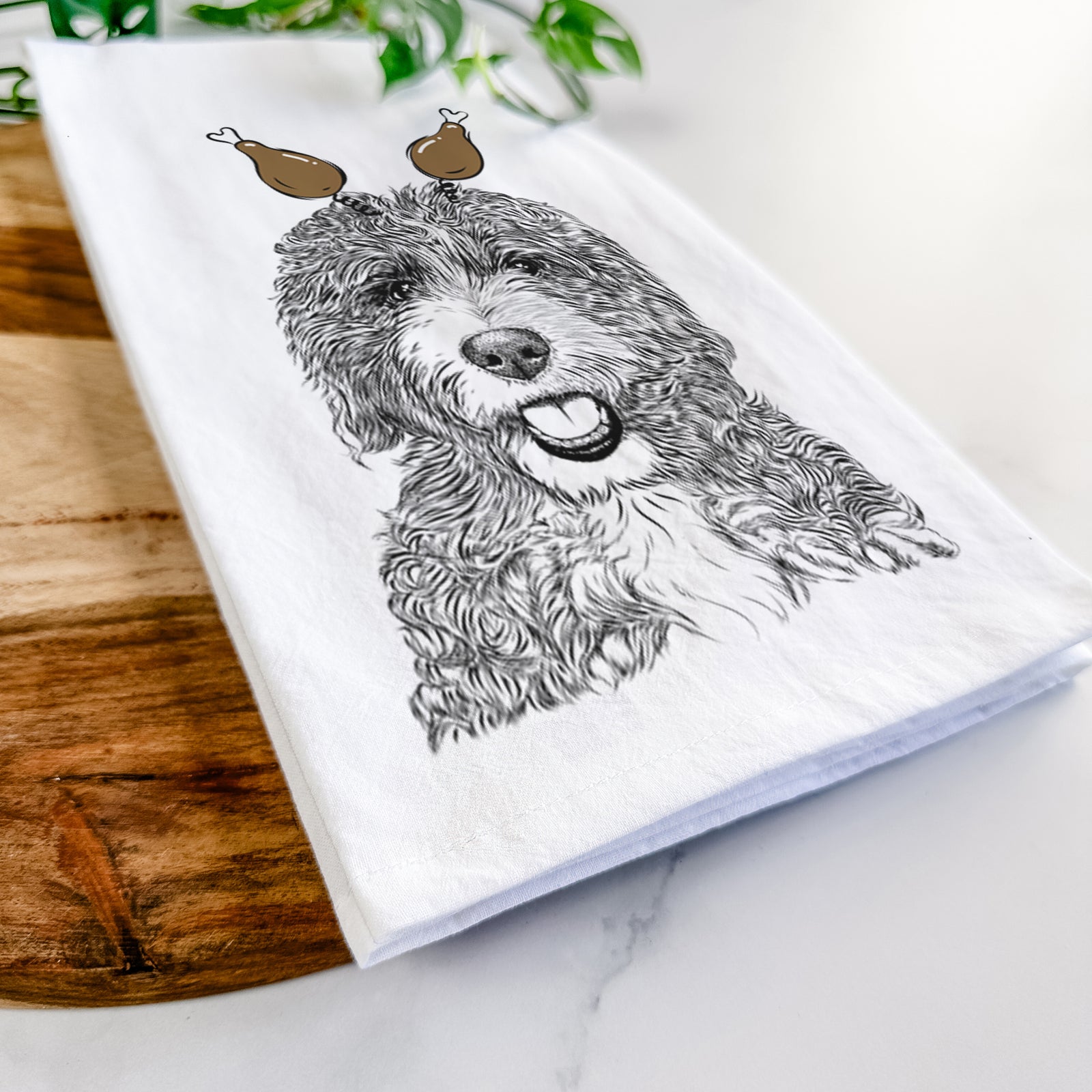Hand-drawn sketch of Bash the Bernedoodle with a Thanksgiving turkey headpiece on a tea towel