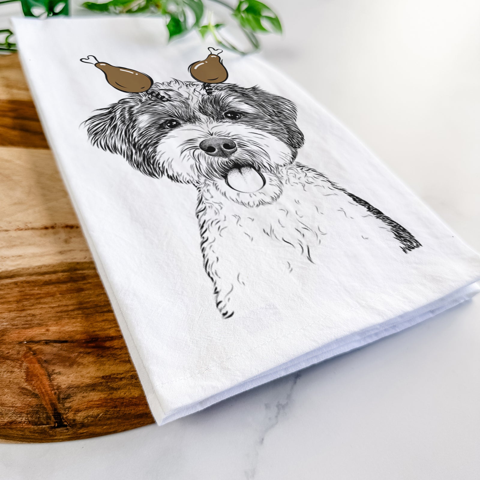 Hand-drawn sketch of Bella the Cockapoo with a Thanksgiving turkey headpiece on a tea towel