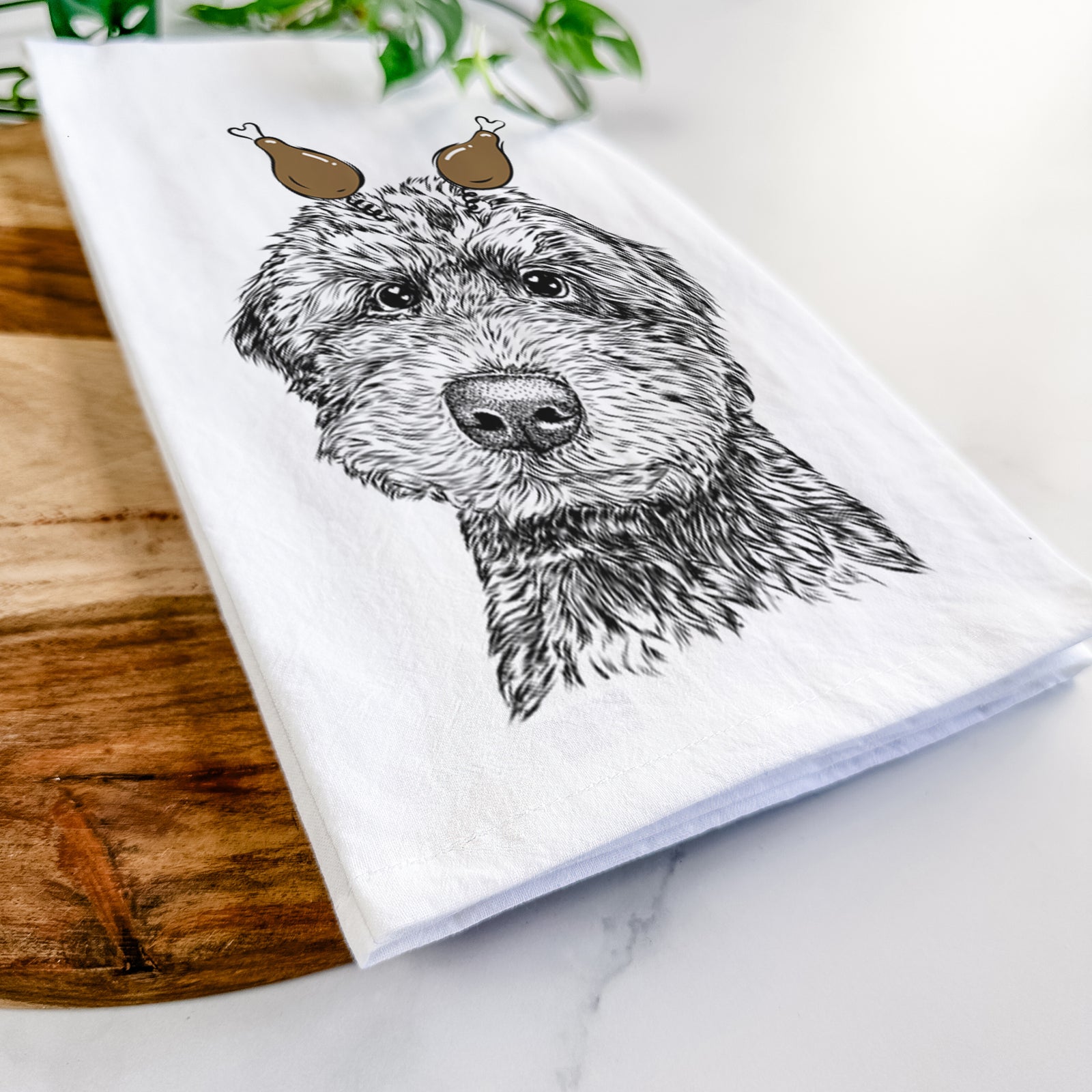 Hand-drawn sketch of Bowser the Whoodle with a Thanksgiving turkey headpiece on a tea towel