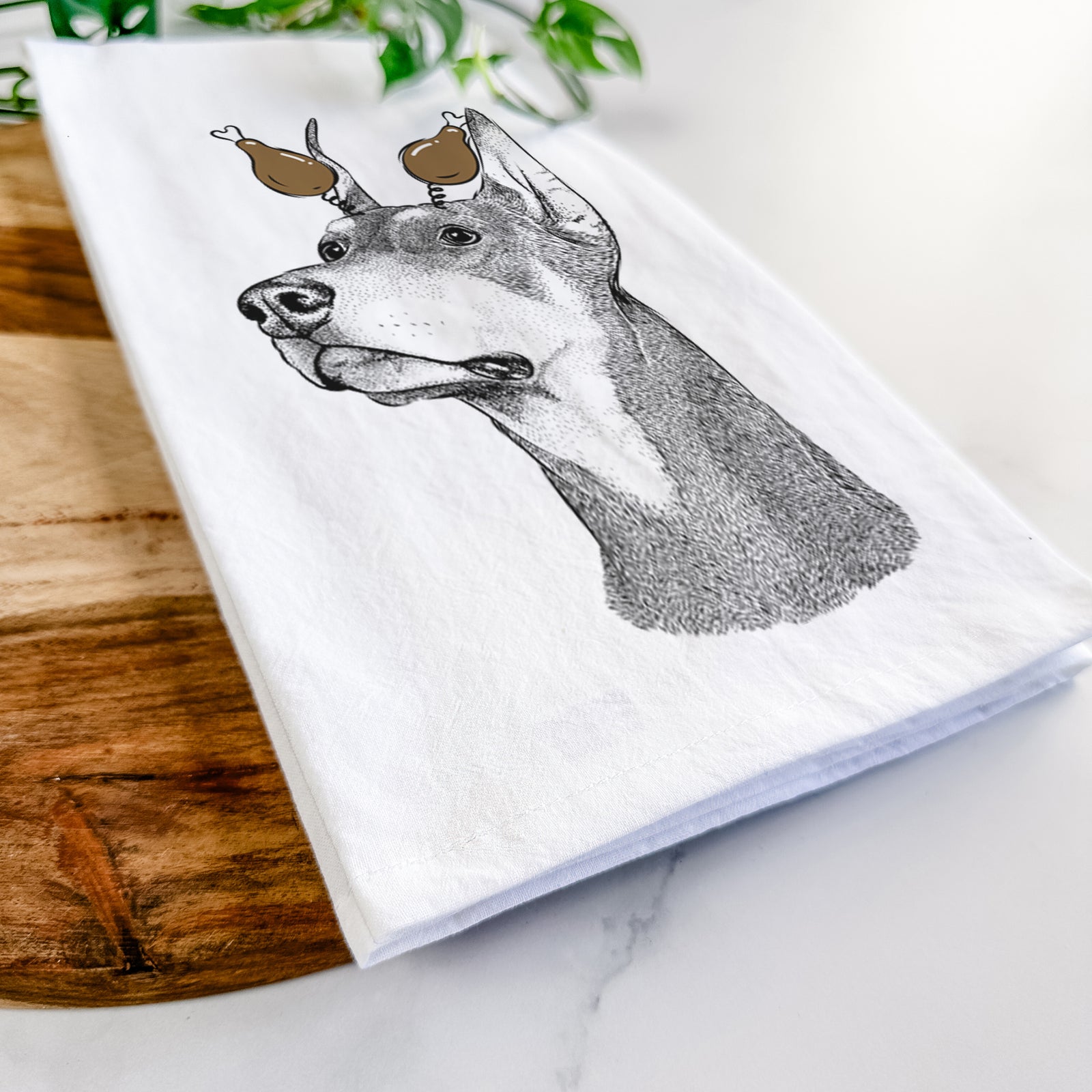 Hand-drawn sketch of Cenza the Doberman Pinscher with a Thanksgiving turkey headpiece on a tea towel