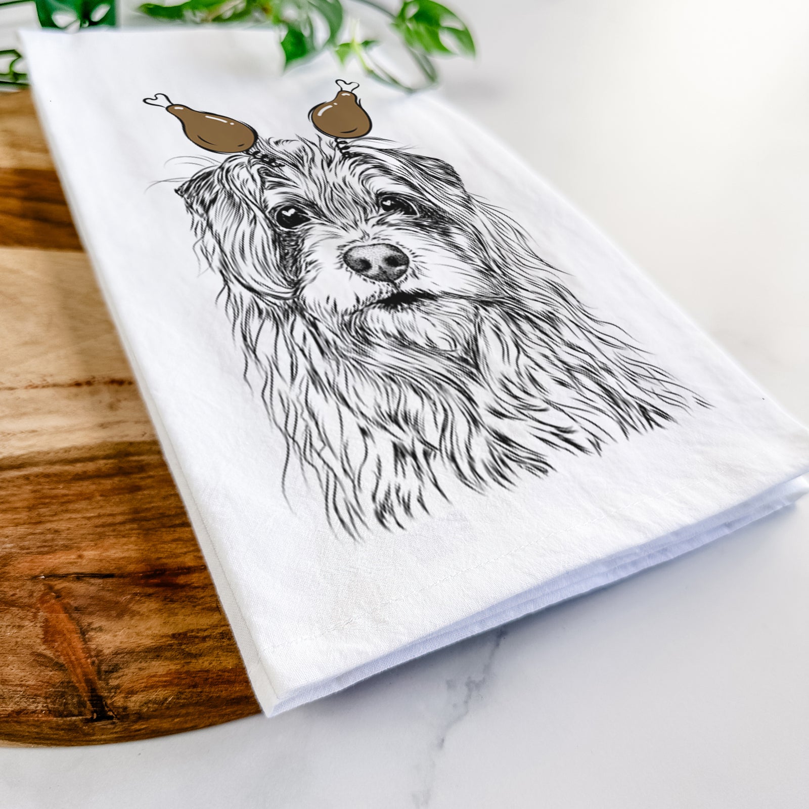 Hand-drawn sketch of Chester the Terrier Mix with a Thanksgiving turkey headpiece on a tea towel