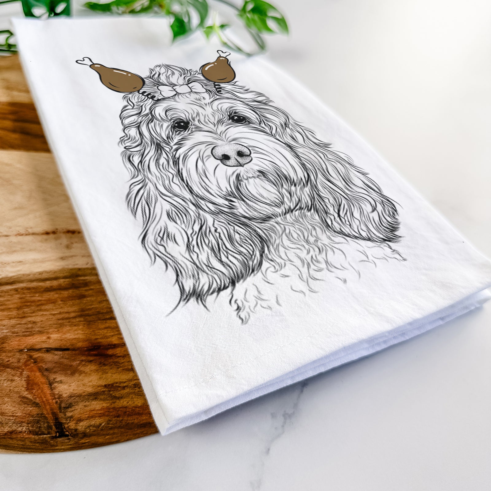 Hand-drawn sketch of Chloe the Cockapoo with a Thanksgiving turkey headpiece on a tea towel