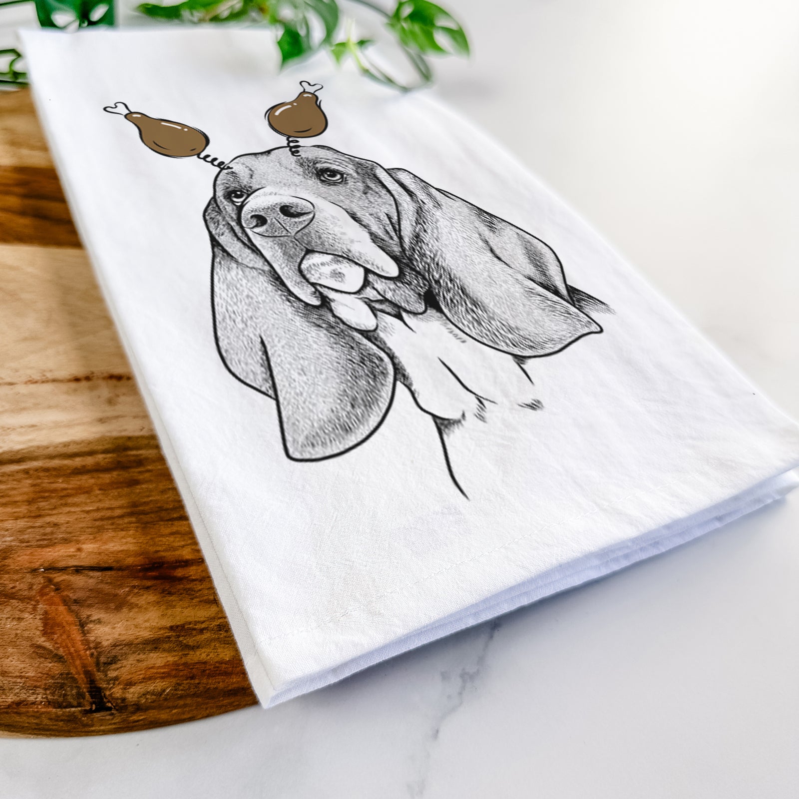 Hand-drawn sketch of Cooper the Basset Hound with a Thanksgiving turkey headpiece on a tea towel
