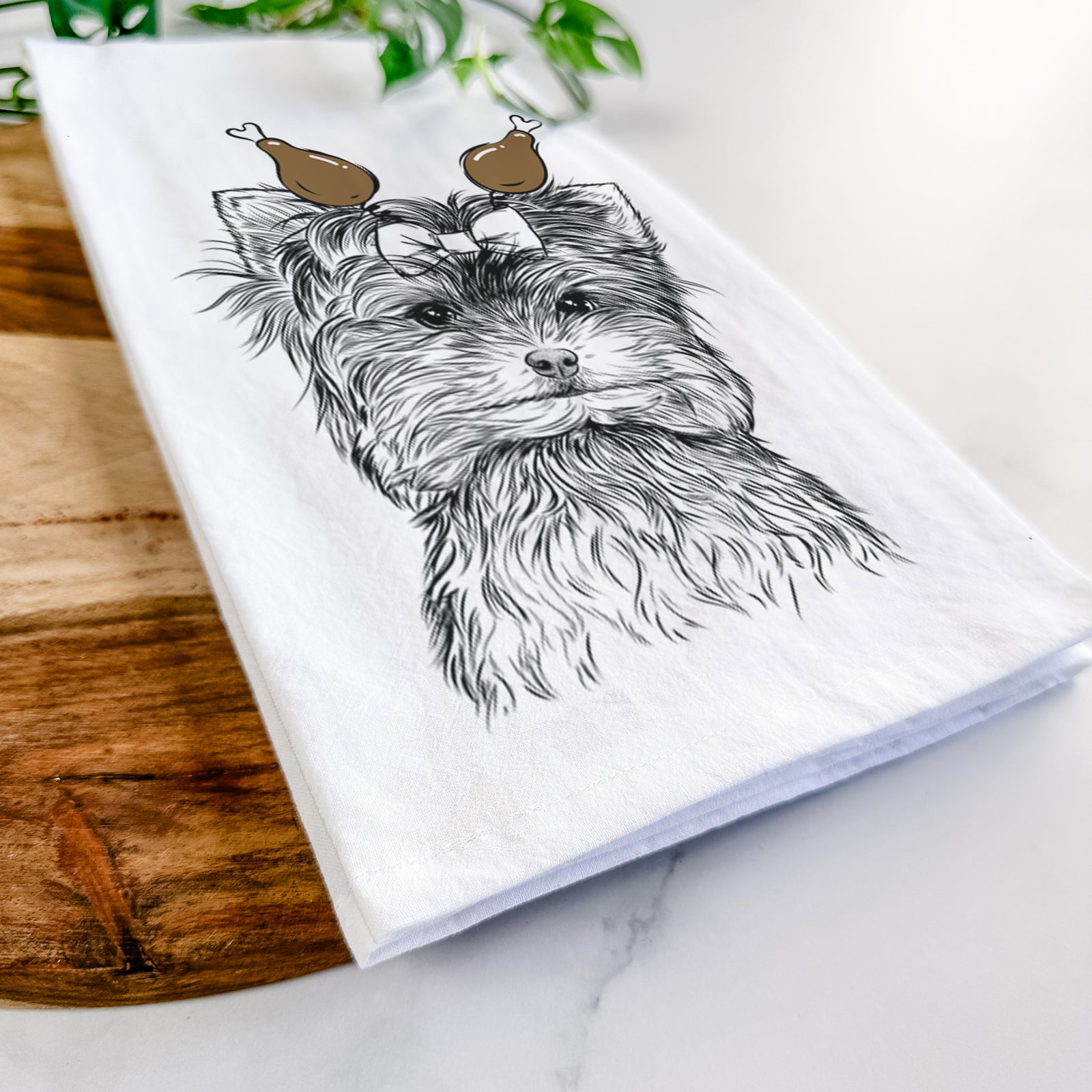Hand-drawn sketch of Cricket the Biewer Terrier with a Thanksgiving turkey headpiece on a tea towel