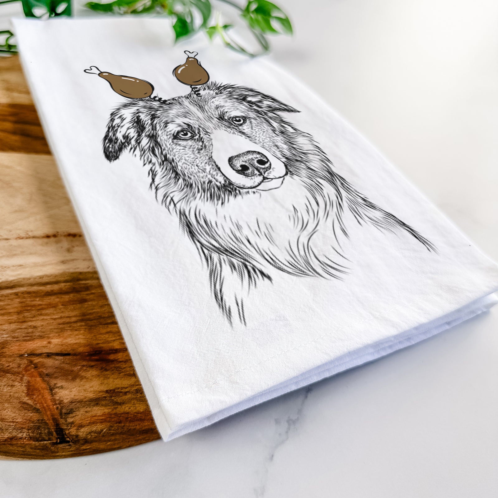 Hand-drawn sketch of Cynder the English Shepherd with a Thanksgiving turkey headpiece on a tea towel