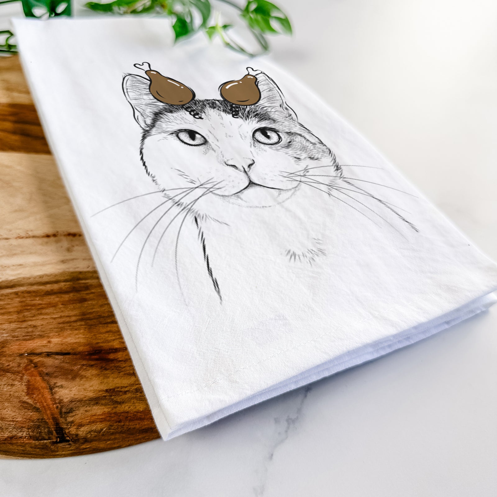 Hand-drawn sketch of Denver the Calico Cat with a Thanksgiving turkey headpiece on a tea towel