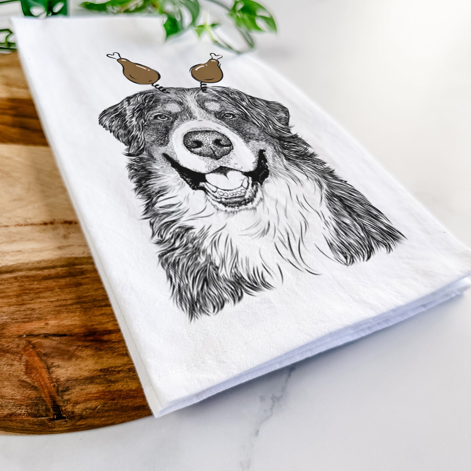 Hand-drawn sketch of Eiger the Bernese Mountain Dog with a Thanksgiving turkey headpiece on a tea towel