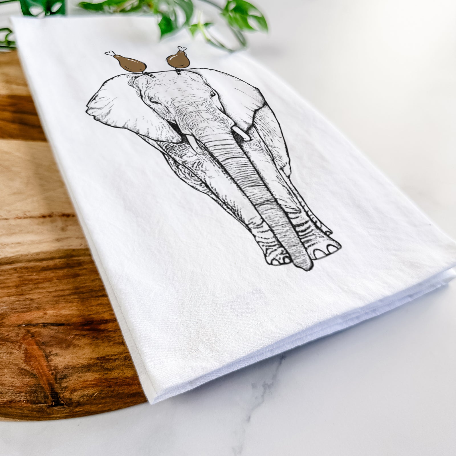 Hand-drawn sketch of Ella the Elephant with a Thanksgiving turkey headpiece on a tea towel
