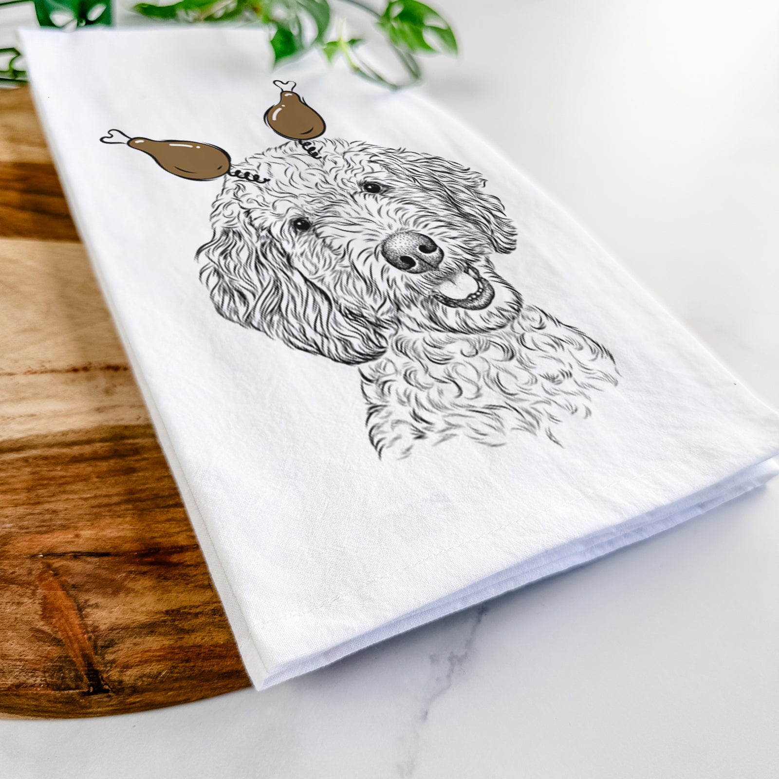 Hand-drawn sketch of Gizmo the Goldendoodle with a Thanksgiving turkey headpiece on a tea towel