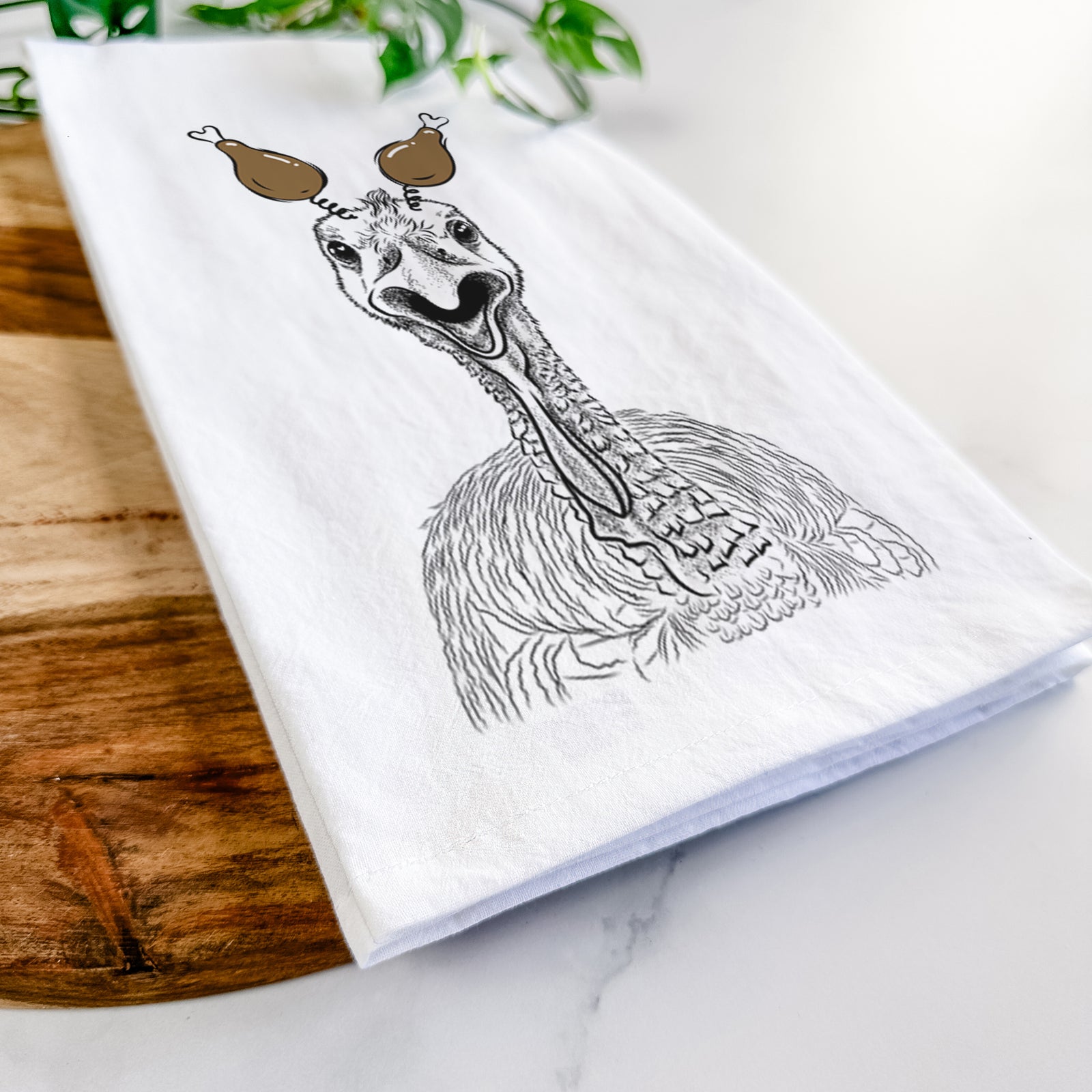 Hand-drawn sketch of Gobble the Turkey with a Thanksgiving turkey headpiece on a tea towel