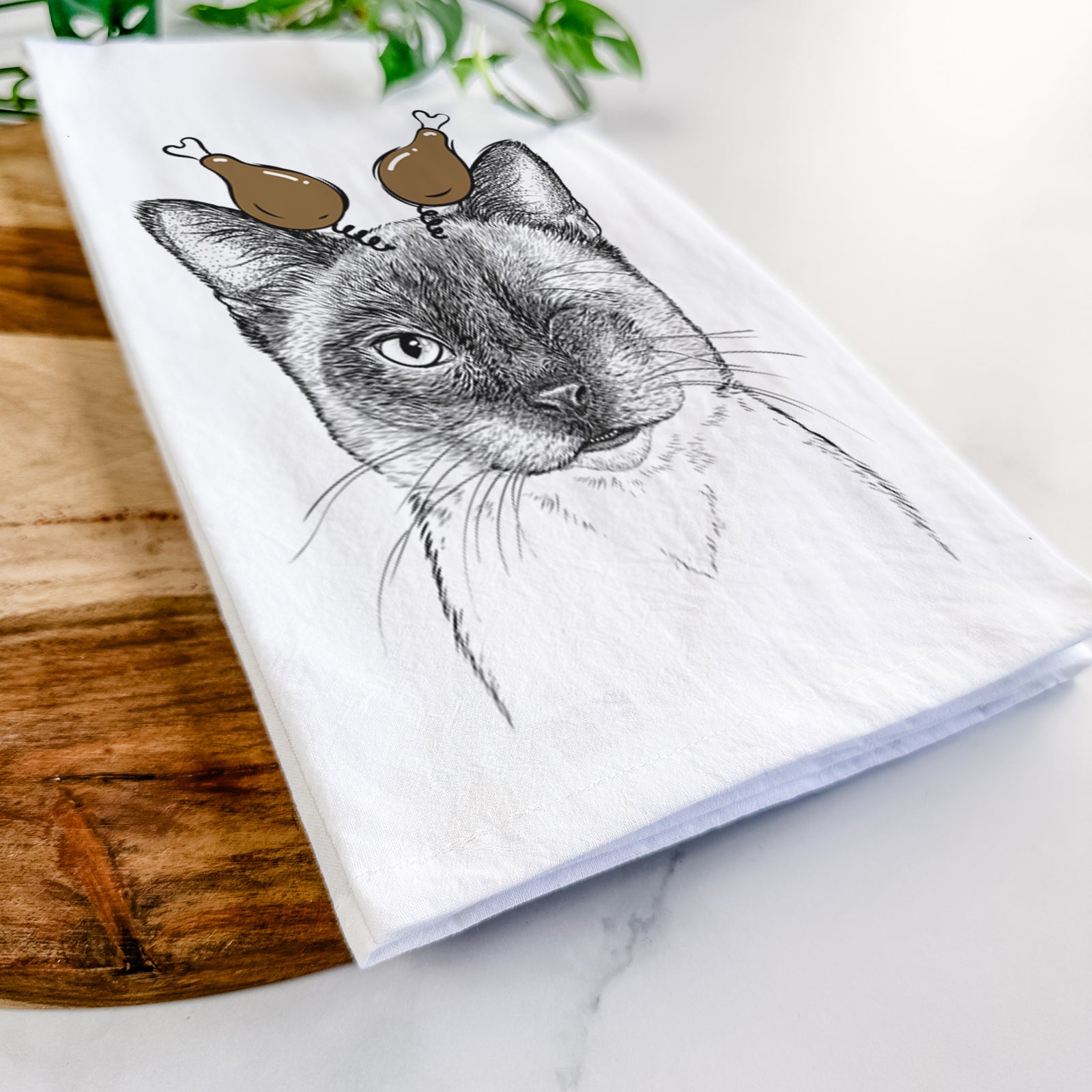 Hand-drawn sketch of Hoggle the Siamese Cat with a Thanksgiving turkey headpiece on a tea towel