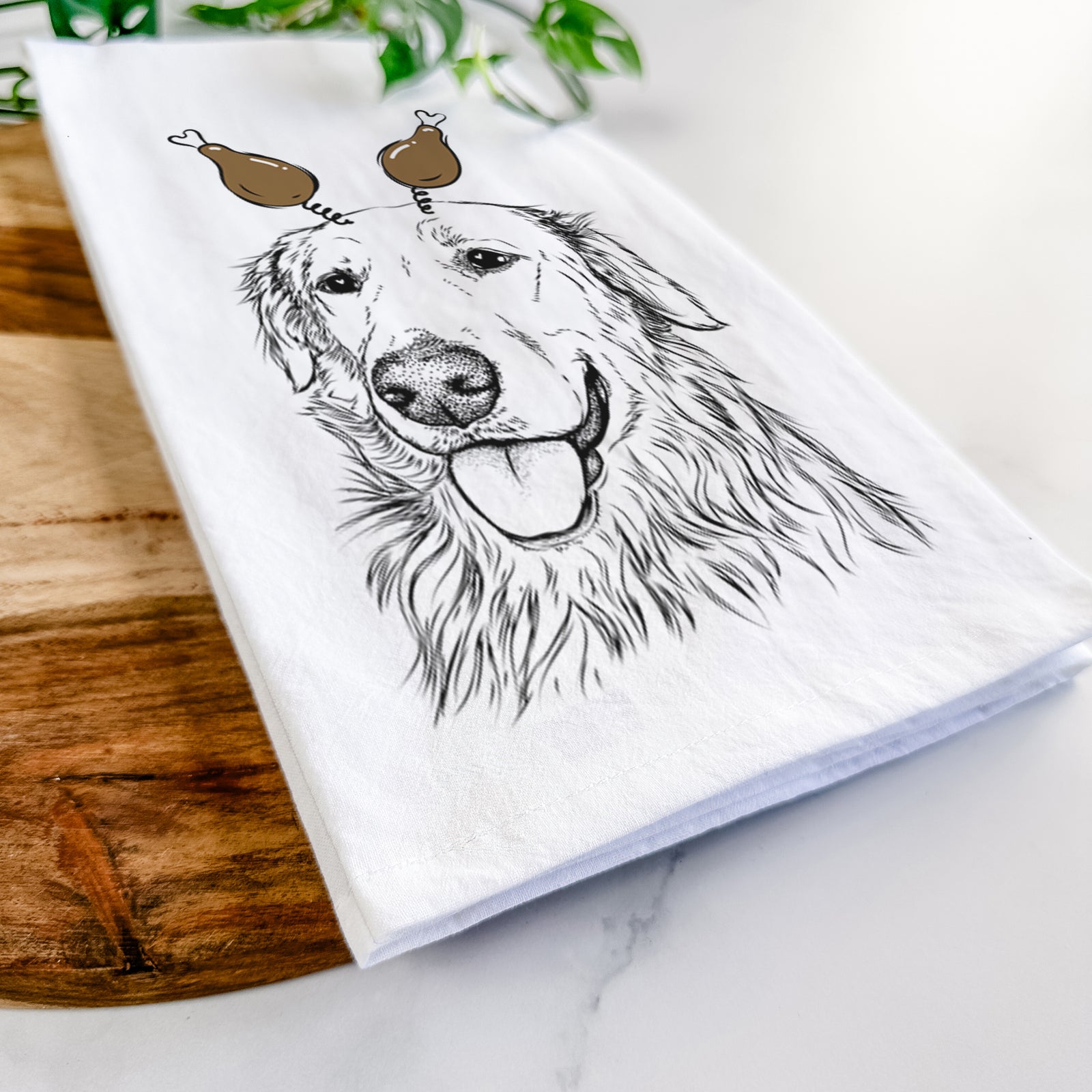 Hand-drawn sketch of Hopper the Golden Retriever with a Thanksgiving turkey headpiece on a tea towel