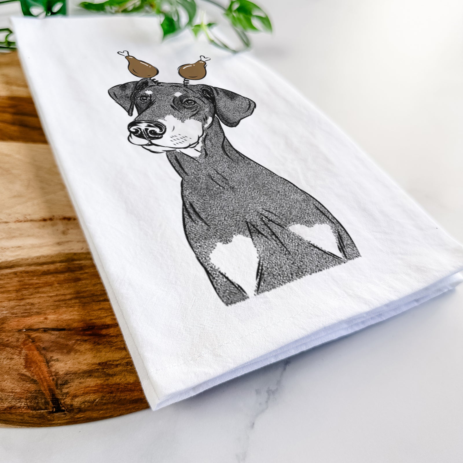 Hand-drawn sketch of Iroh the Doberman Pinscher with a Thanksgiving turkey headpiece on a tea towel