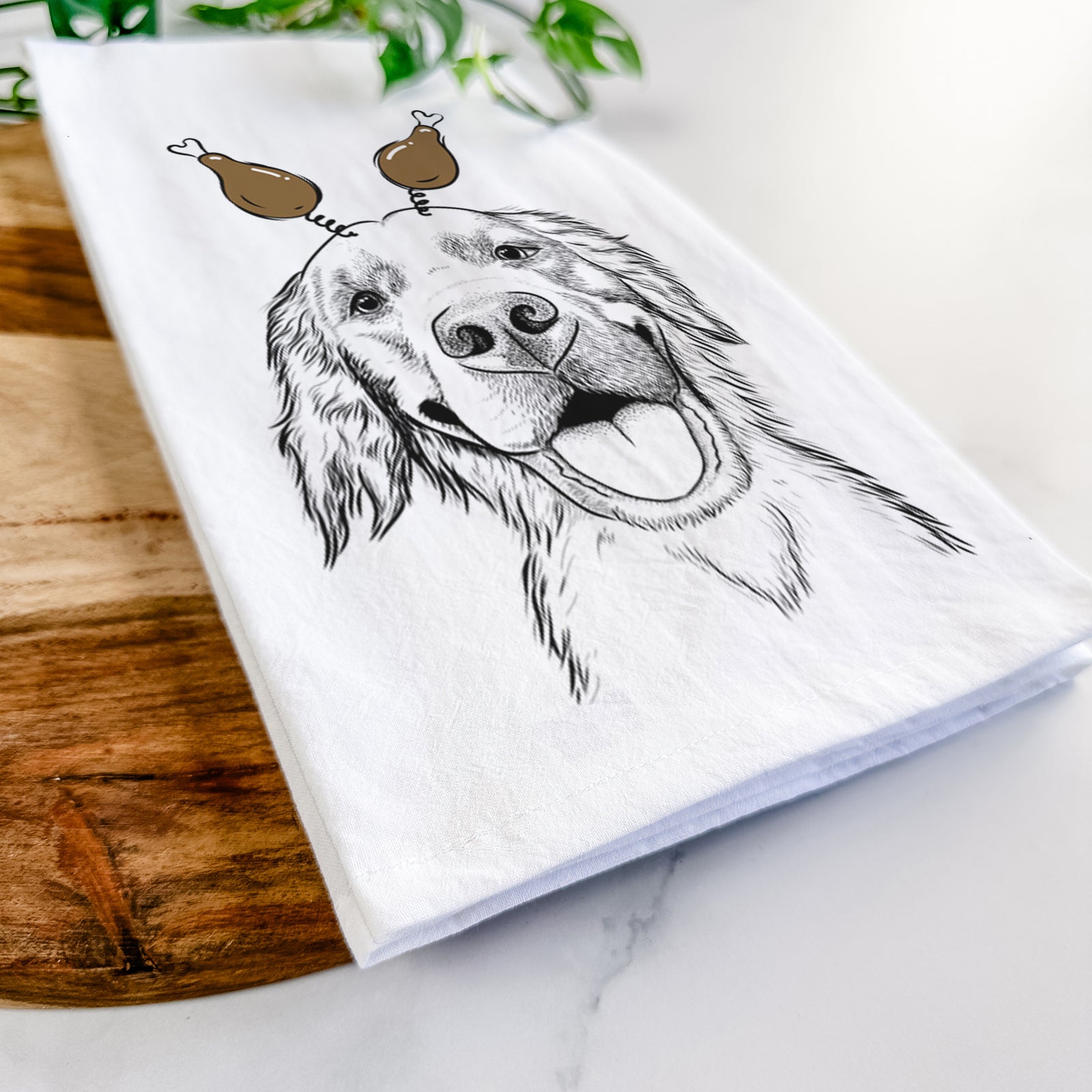 Hand-drawn sketch of Jordy the Golden Retriever with a Thanksgiving turkey headpiece on a tea towel