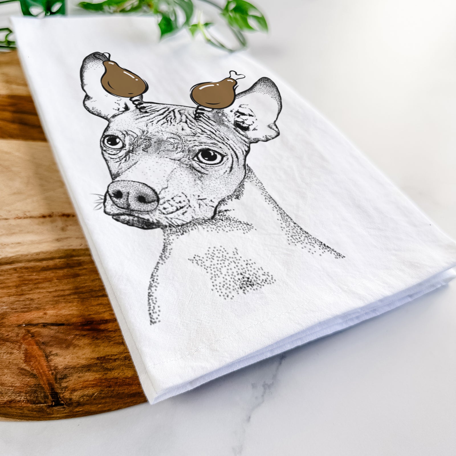 Hand-drawn sketch of Kahlo the Xoloitzcuintli with a Thanksgiving turkey headpiece on a tea towel