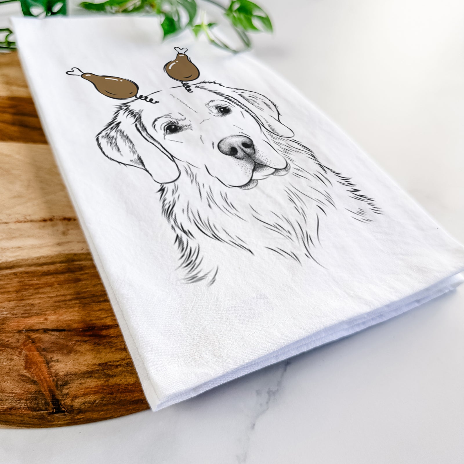 Hand-drawn sketch of Kula the Golden Retriever with a Thanksgiving turkey headpiece on a tea towel
