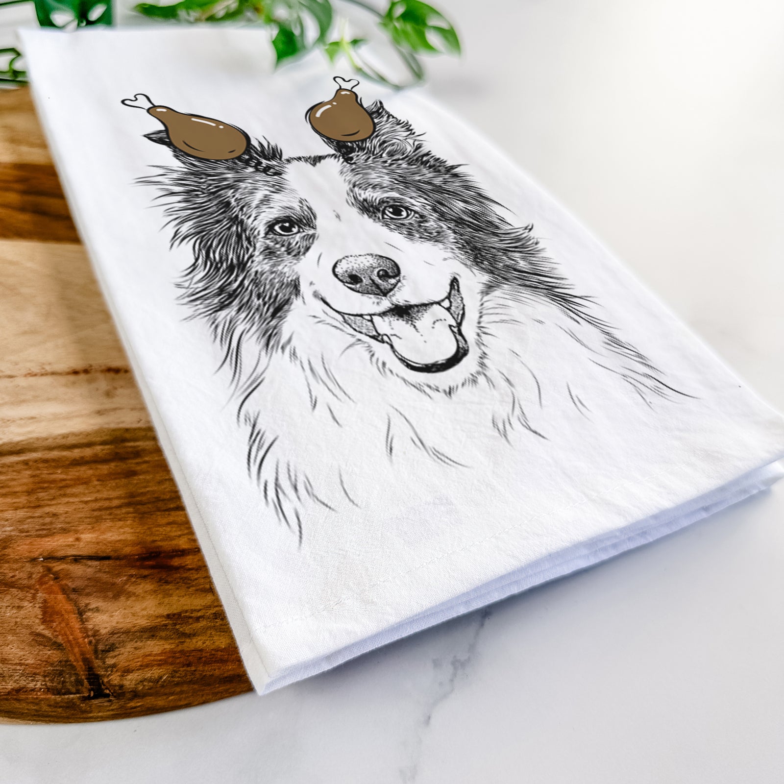 Hand-drawn sketch of Kylee the Border Collie with a Thanksgiving turkey headpiece on a tea towel