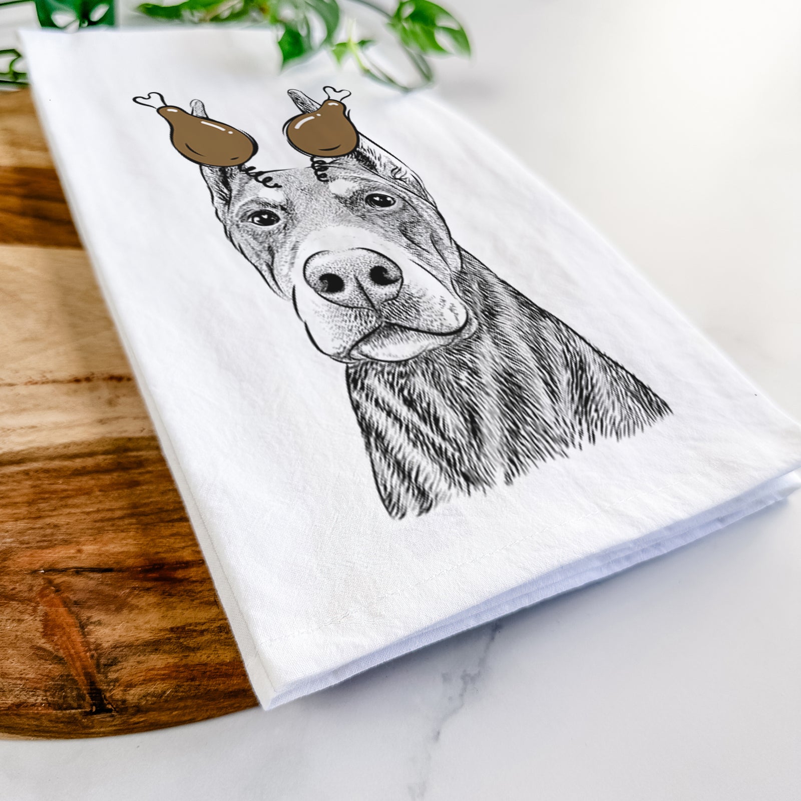 Hand-drawn sketch of Luna the Doberman Pinscher with a Thanksgiving turkey headpiece on a tea towel