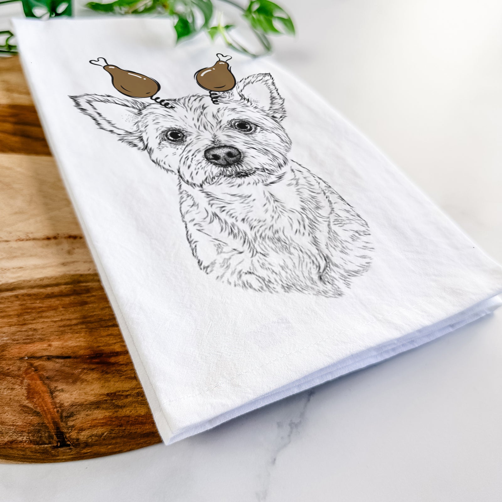 Hand-drawn sketch of Mango the Yorker Cairn Terrier Mix with a Thanksgiving turkey headpiece on a tea towel