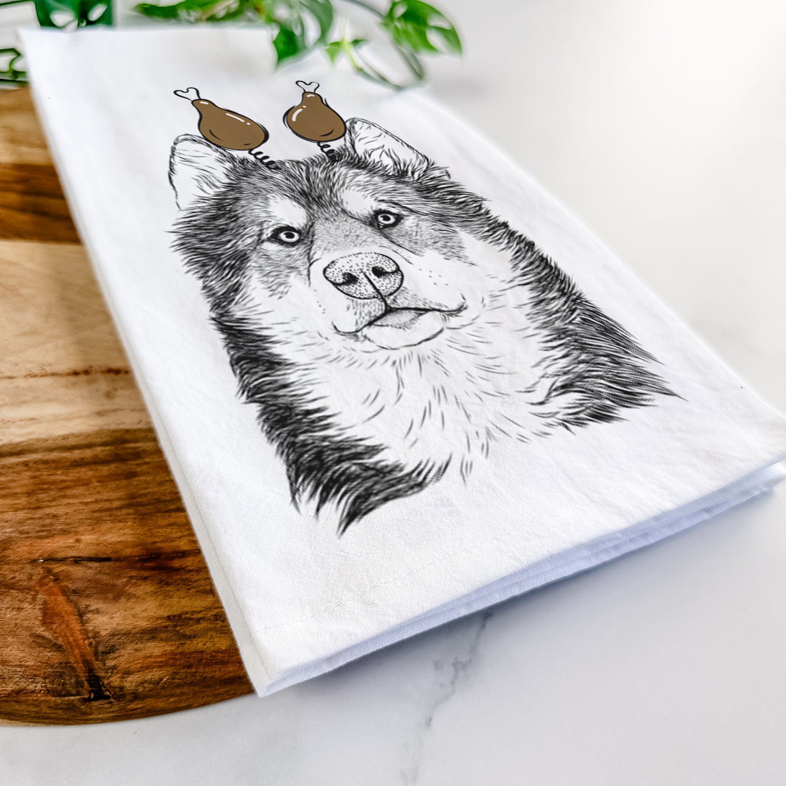 Hand-drawn sketch of Oskar the Canadian Eskimo Dog with a Thanksgiving turkey headpiece on a tea towel