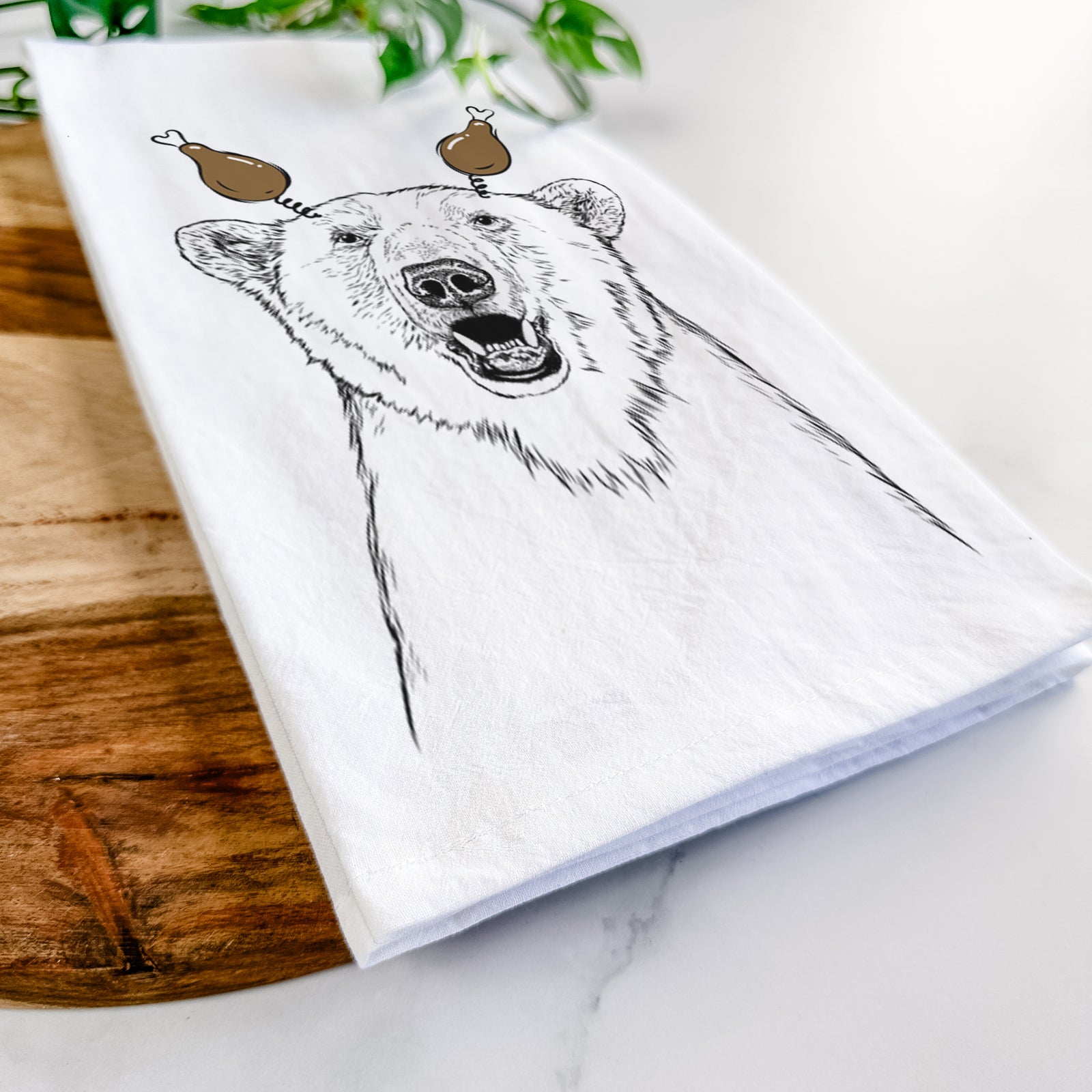 Hand-drawn sketch of Oslo the Polar Bear with a Thanksgiving turkey headpiece on a tea towel