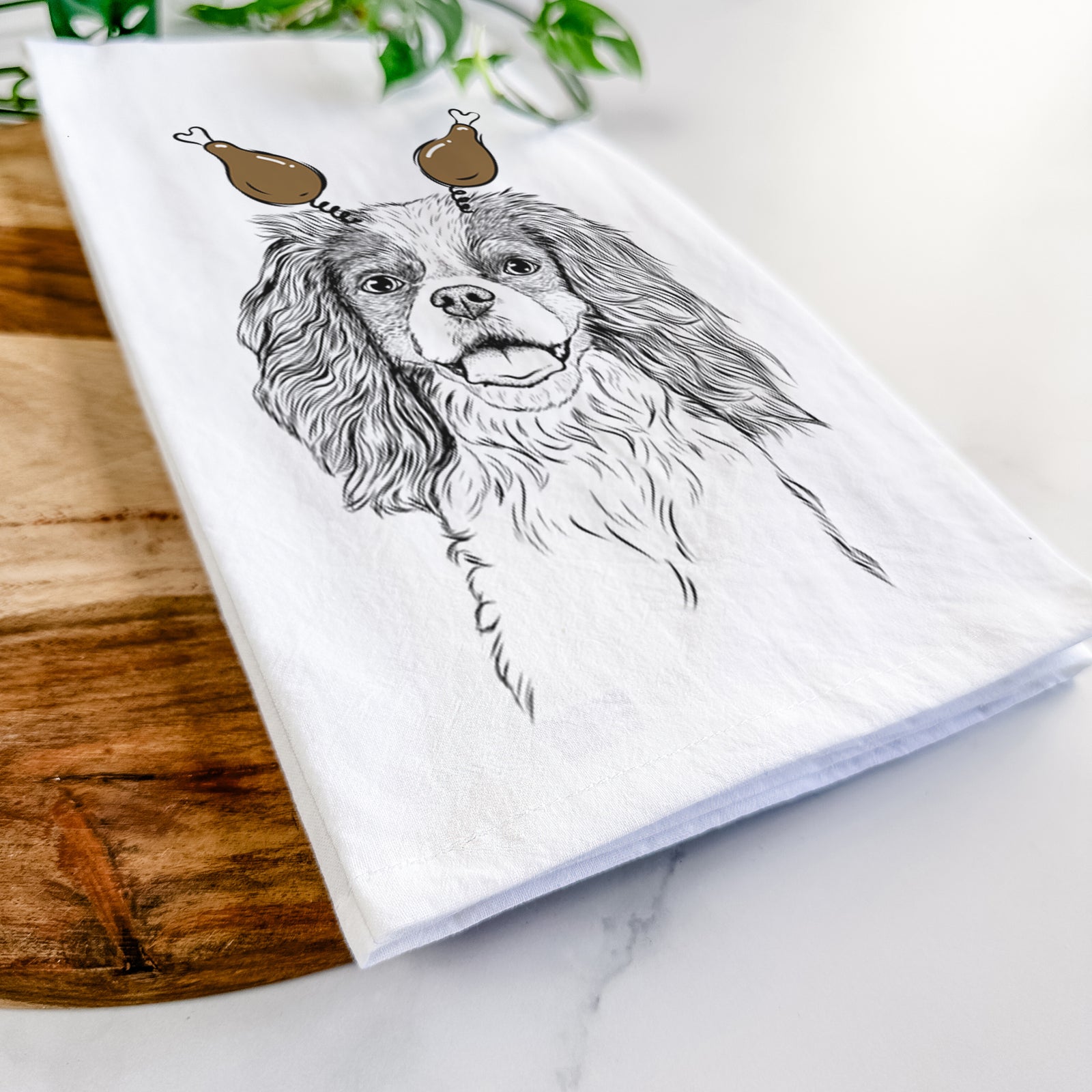 Hand-drawn sketch of Poppy the Cavalier King Charles Spaniel with a Thanksgiving turkey headpiece on a tea towel