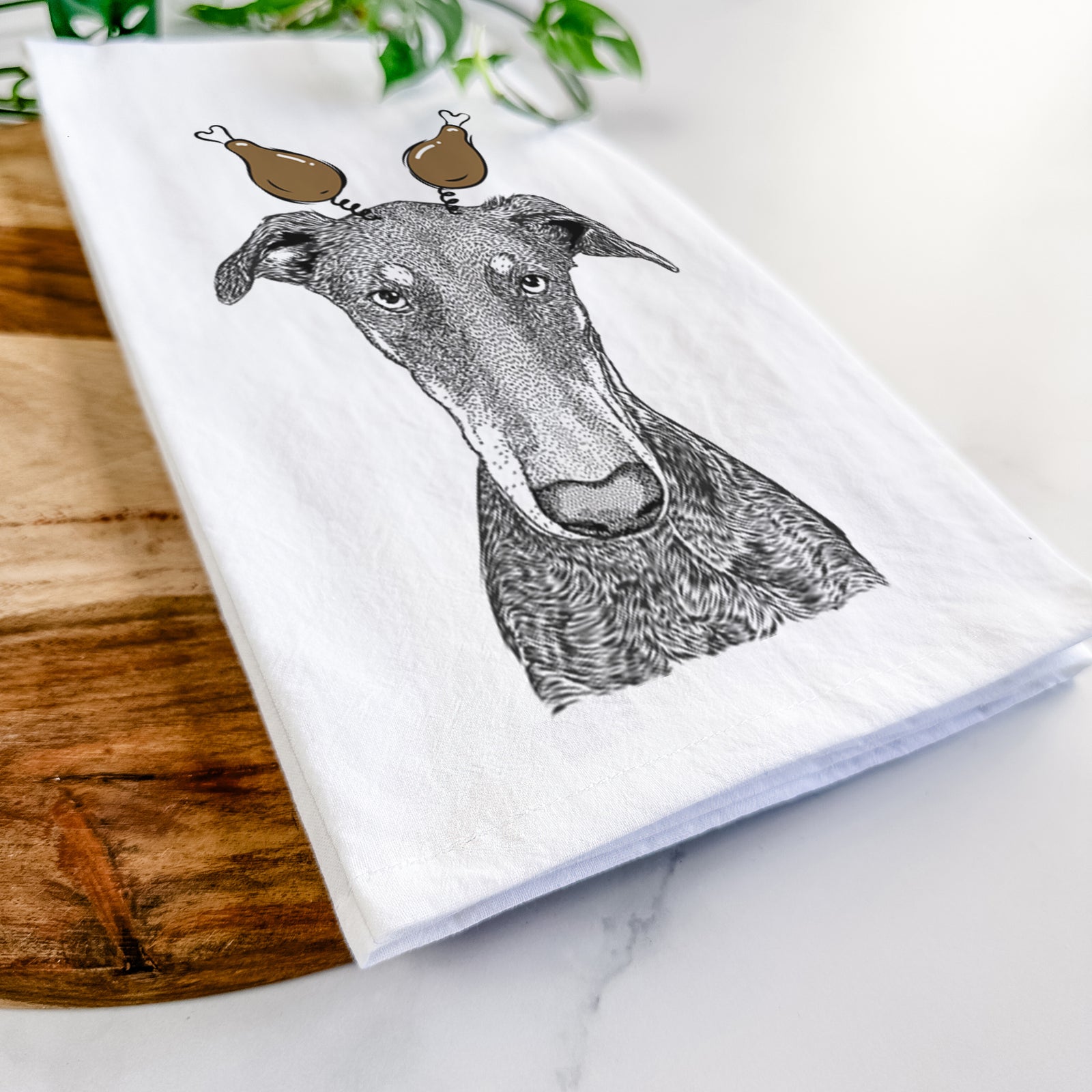 Hand-drawn sketch of Princess Fiona the Doberman Pinscher with a Thanksgiving turkey headpiece on a tea towel