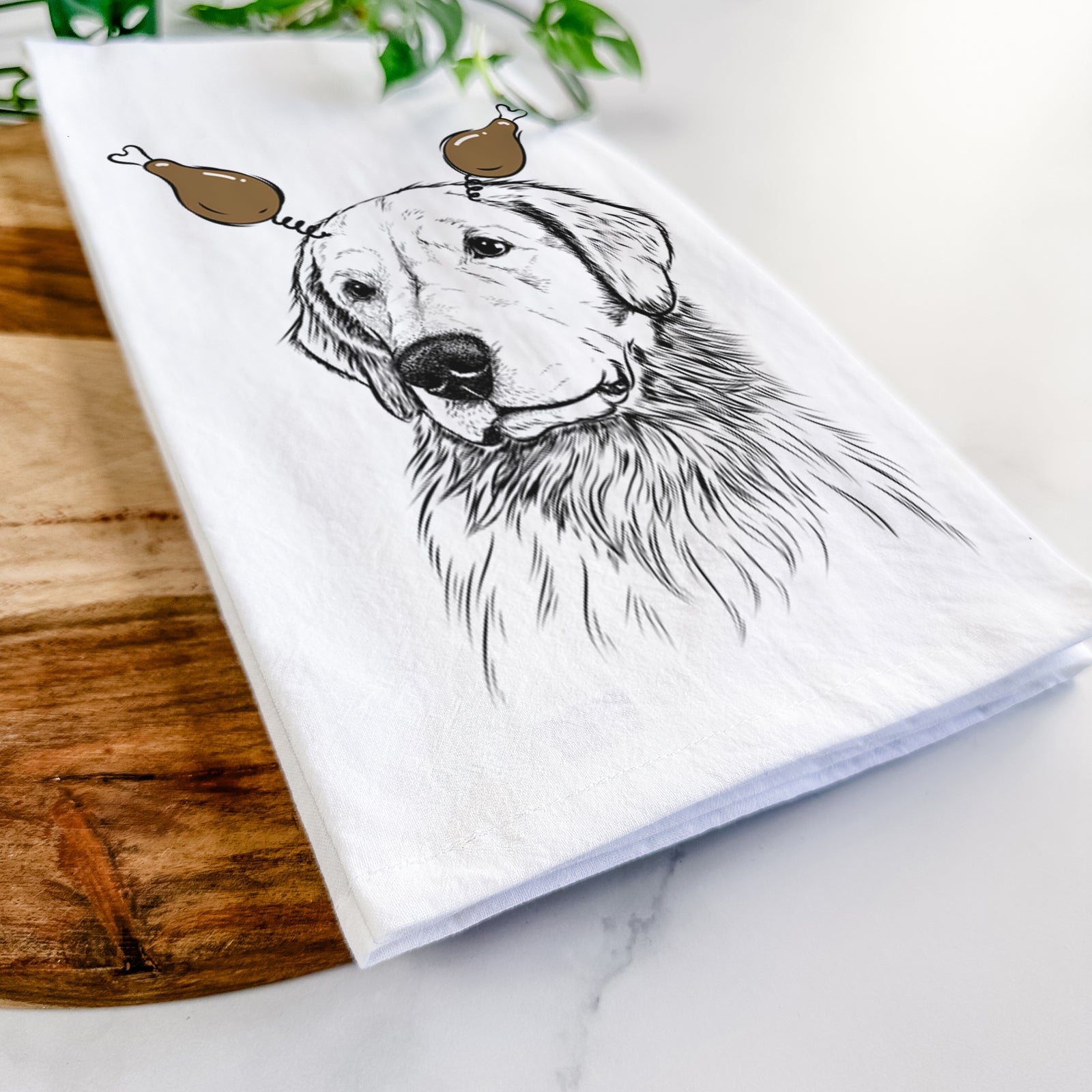 Hand-drawn sketch of Quinn the Golden Retriever with a Thanksgiving turkey headpiece on a tea towel