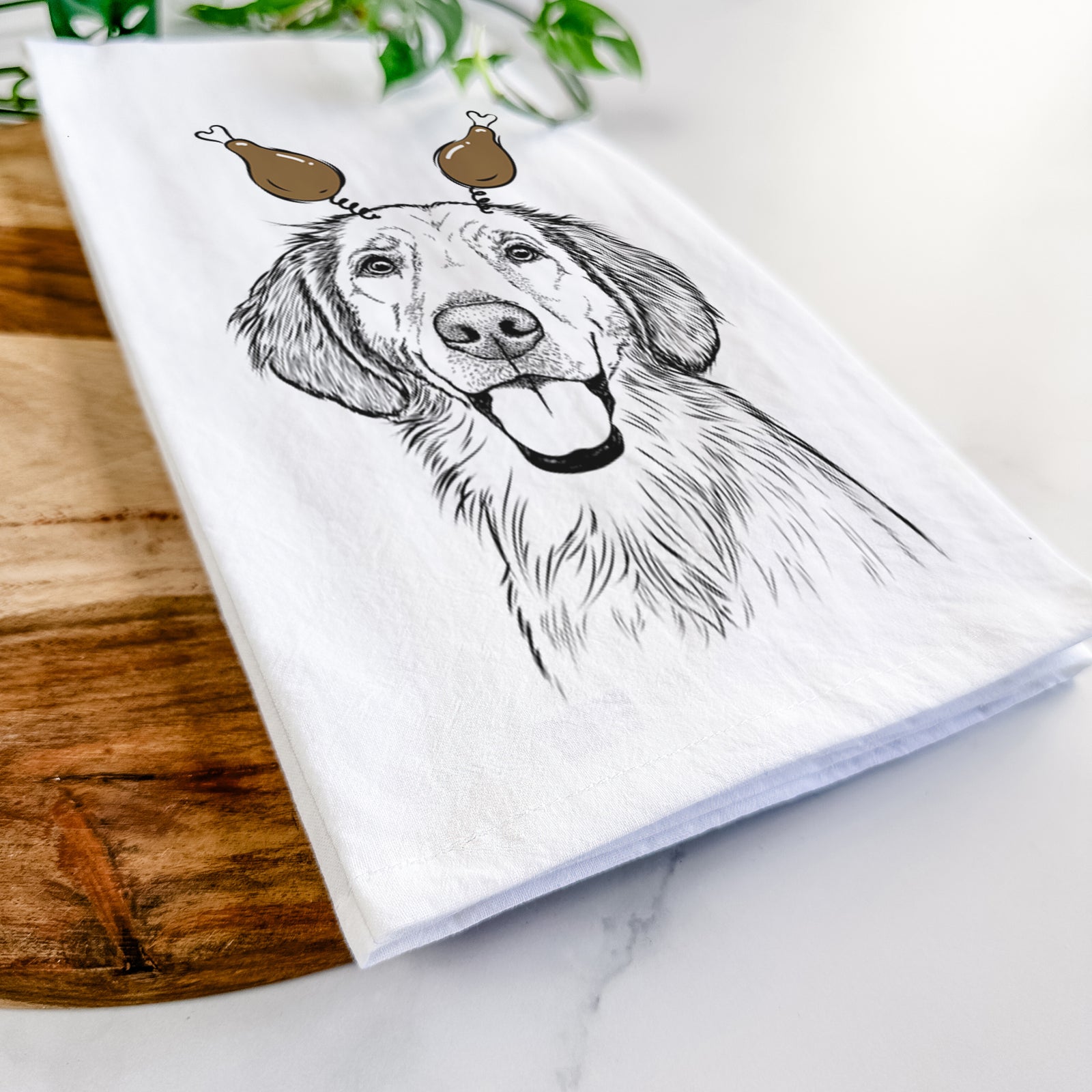 Hand-drawn sketch of Riley the Golden Retriever with a Thanksgiving turkey headpiece on a tea towel