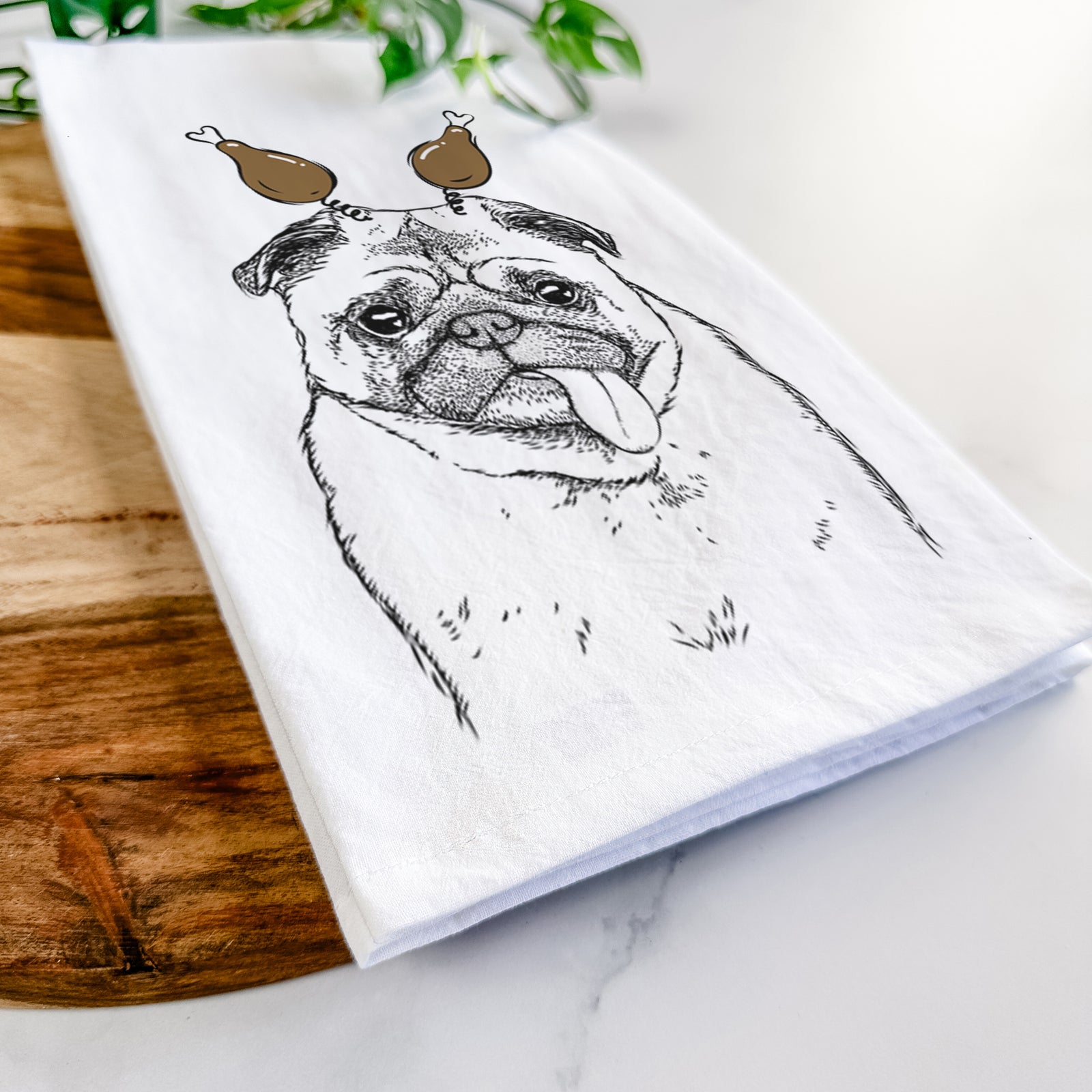 Hand-drawn sketch of Rosie the Pug with a Thanksgiving turkey headpiece on a tea towel