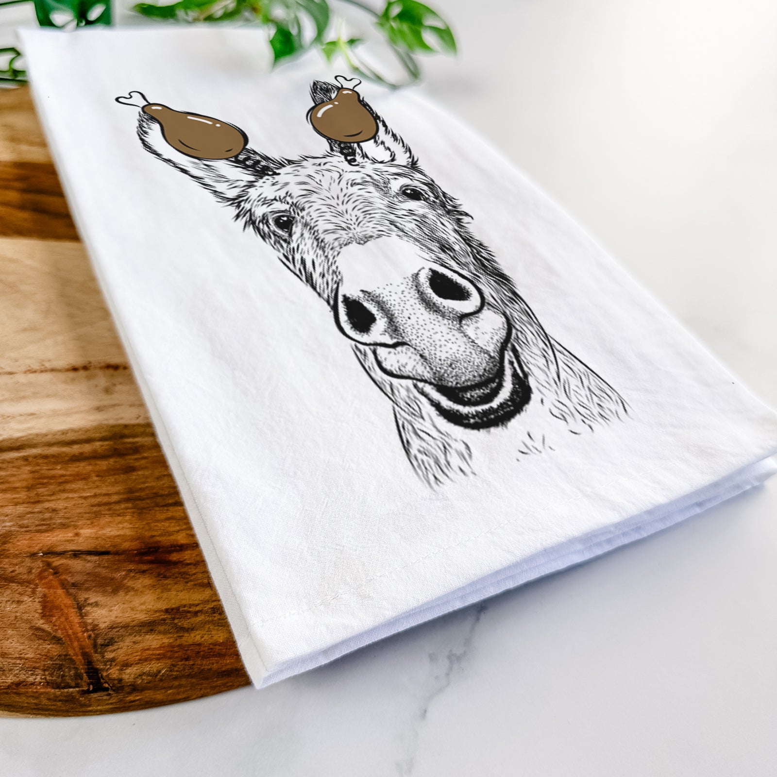 Hand-drawn sketch of Samule the Donkey with a Thanksgiving turkey headpiece on a tea towel