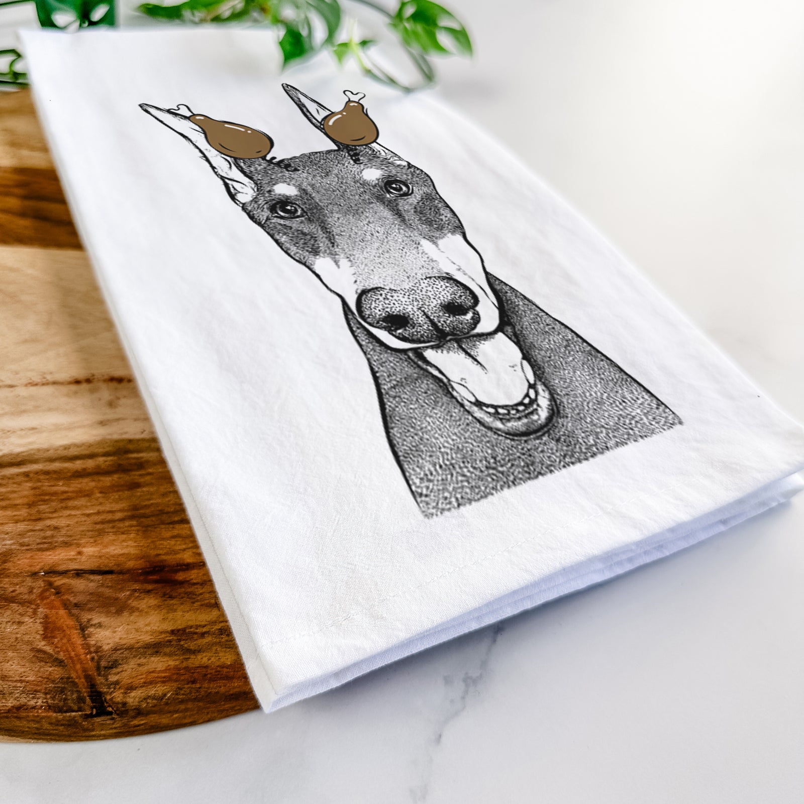 Hand-drawn sketch of Sir Duke the Doberman Pinscher with a Thanksgiving turkey headpiece on a tea towel
