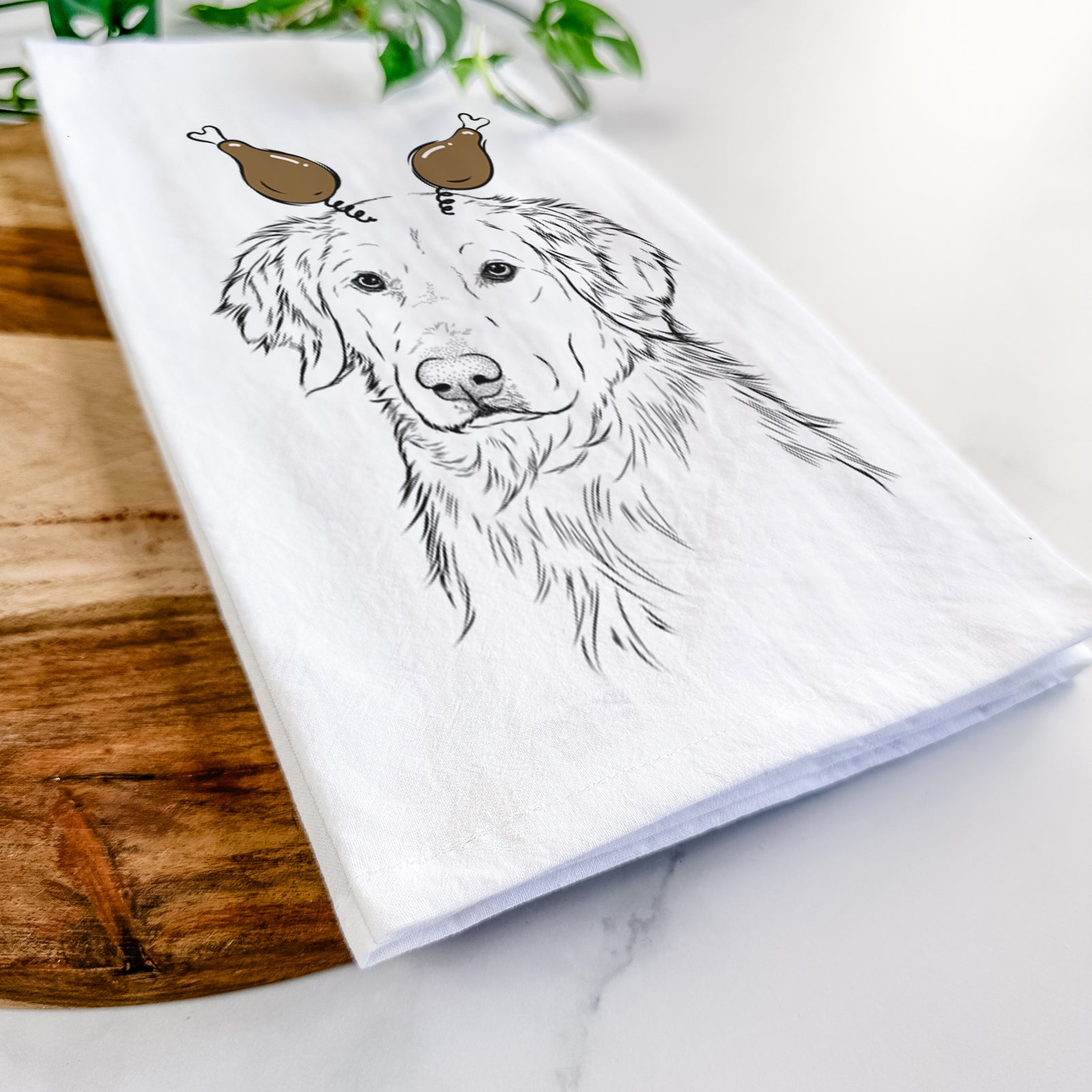 Hand-drawn sketch of Spencer the Golden Retriever with a Thanksgiving turkey headpiece on a tea towel