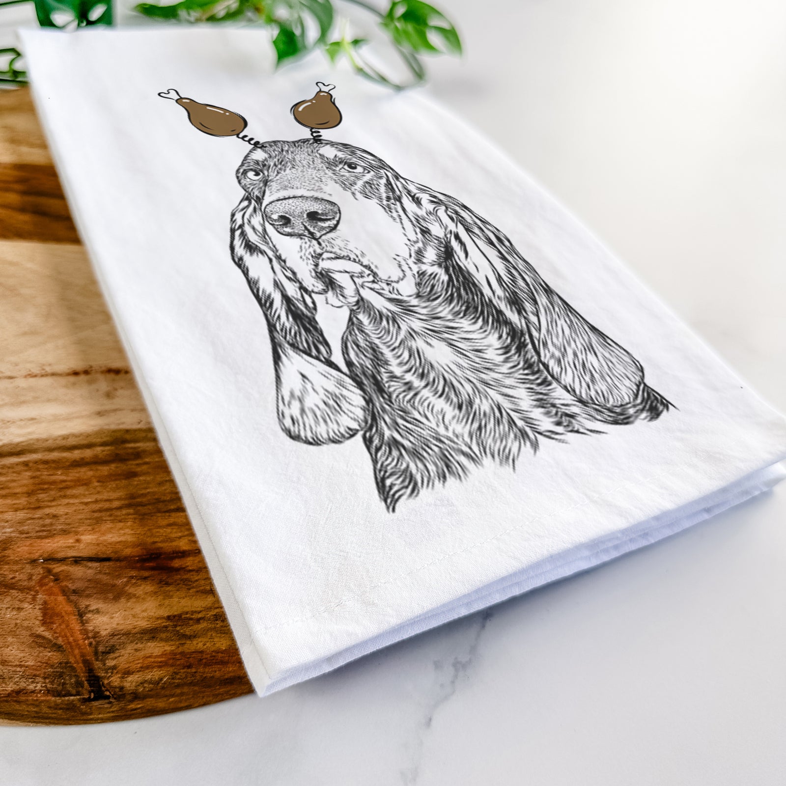 Hand-drawn sketch of Stu the Black and Tan Coonhound with a Thanksgiving turkey headpiece on a tea towel