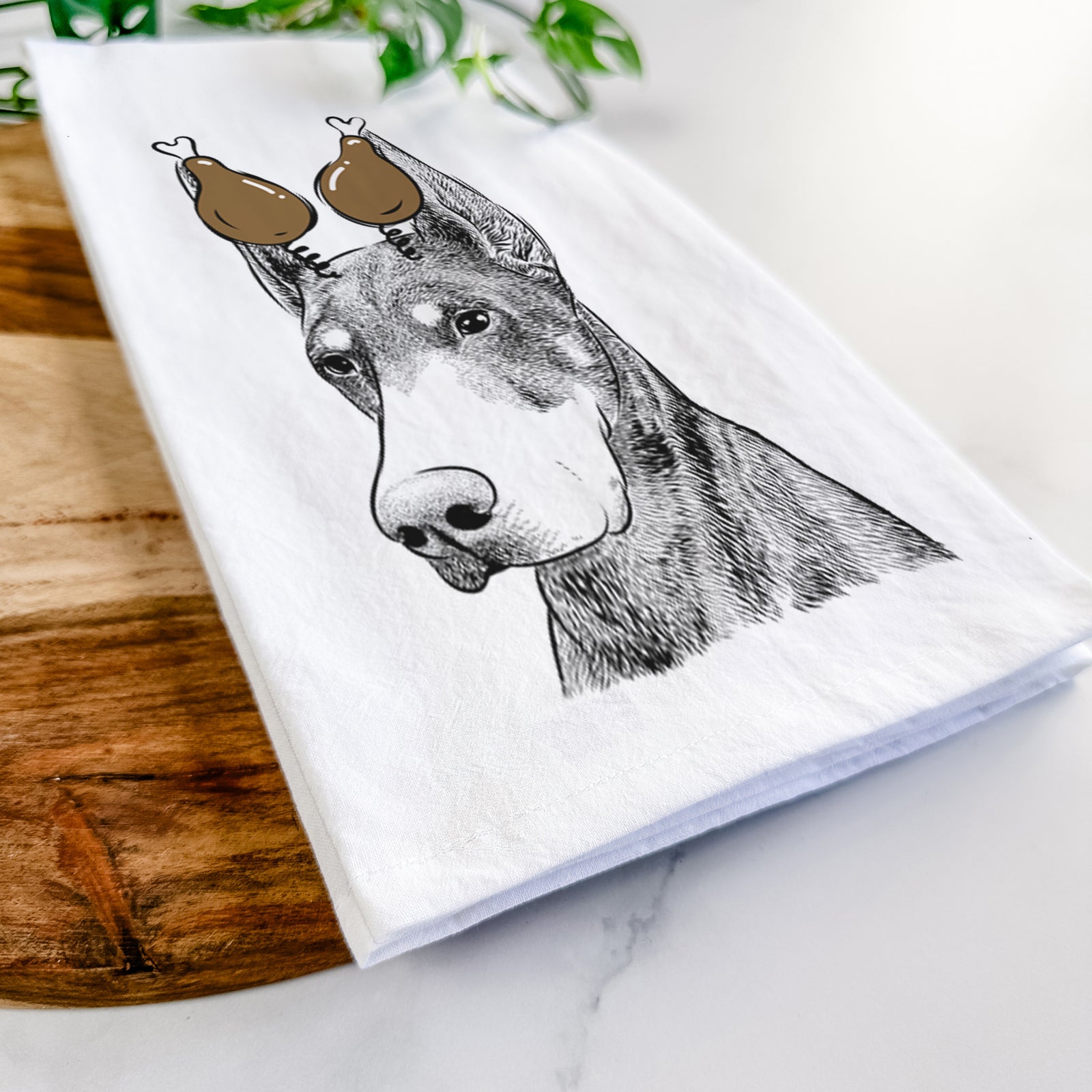 Hand-drawn sketch of Sunny the Doberman Pinscher with a Thanksgiving turkey headpiece on a tea towel