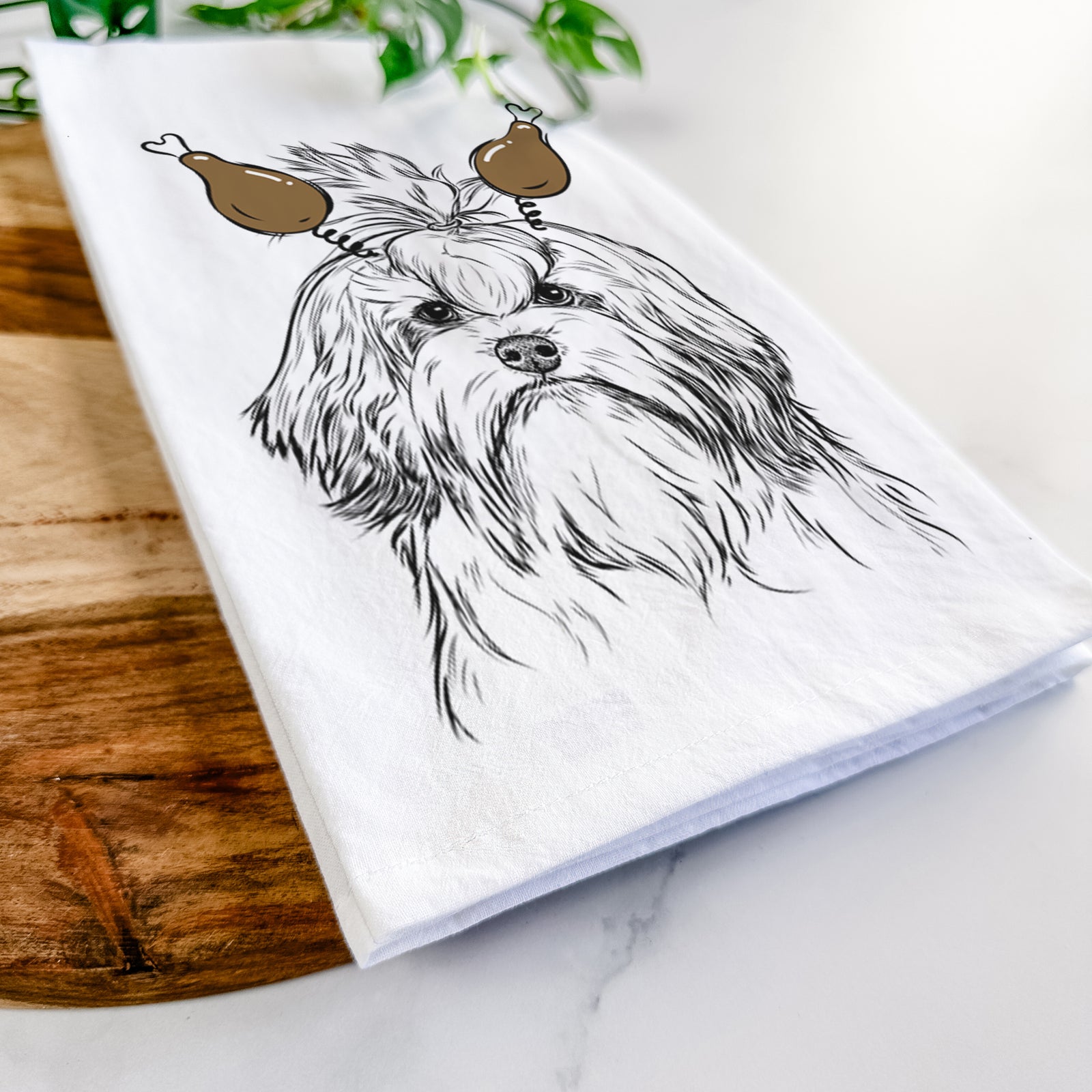 Hand-drawn sketch of Tootsie the Lowchen with a Thanksgiving turkey headpiece on a tea towel