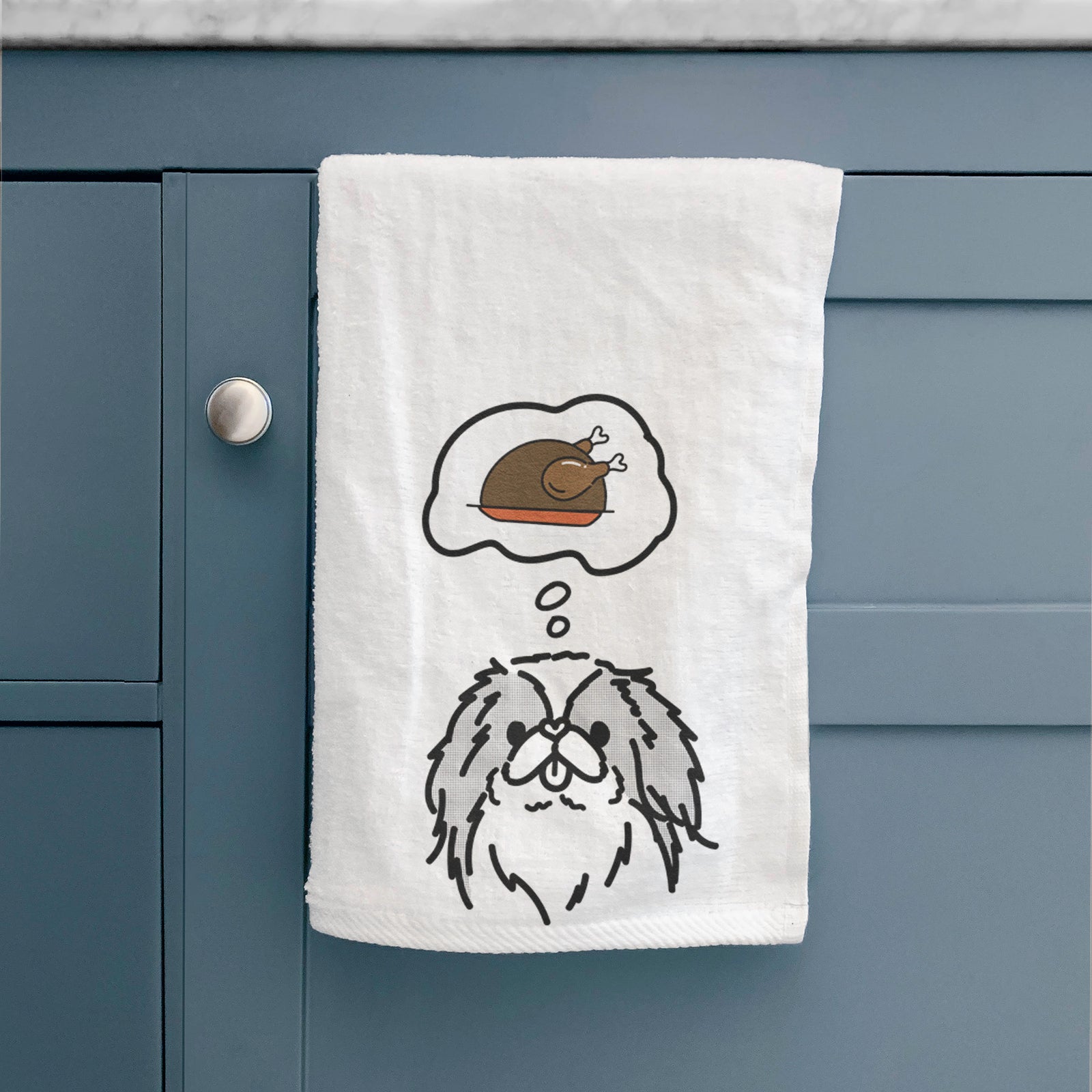 Minimalist line drawing of Macha the Japanese Chin with a little turkey on a decorative hand towel