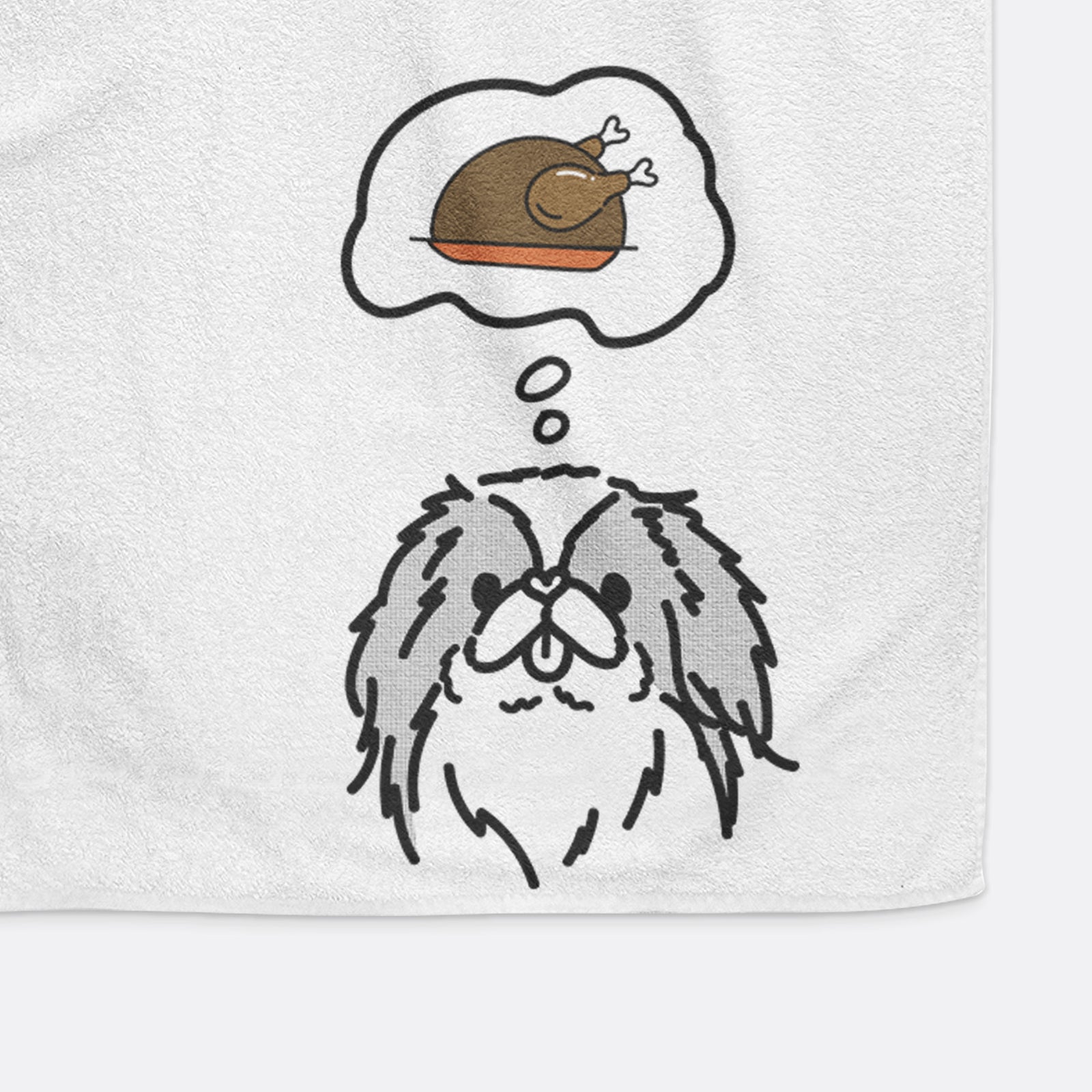 Minimalist line drawing of Macha the Japanese Chin with a little turkey on a decorative hand towel