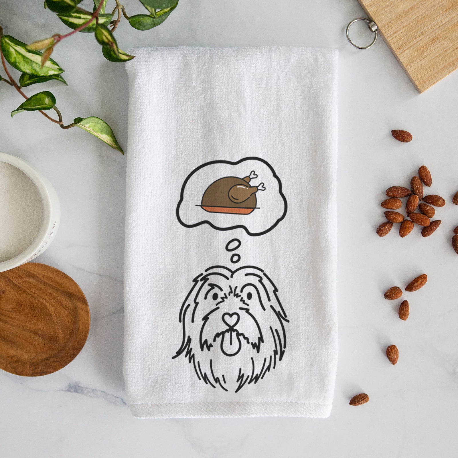 Minimalist line drawing of Tucker the Bearded Collie with a little turkey on a decorative hand towel