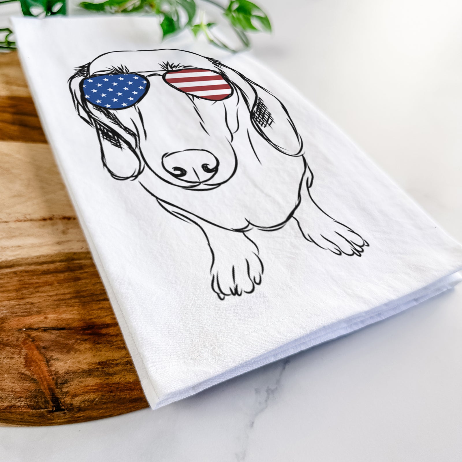 Hand-drawn sketch of Annabelle the Dachshund wearing American flag sunglasses on a tea towel
