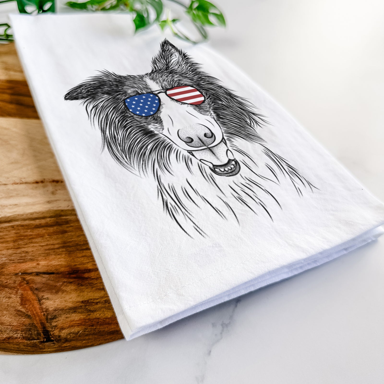Hand-drawn sketch of Archie the Silken Windhound wearing American flag sunglasses on a tea towel