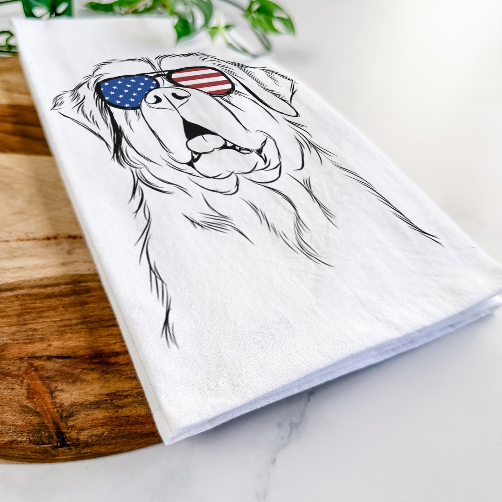 Hand-drawn sketch of Atlas the Saint Bernard wearing American flag sunglasses on a tea towel