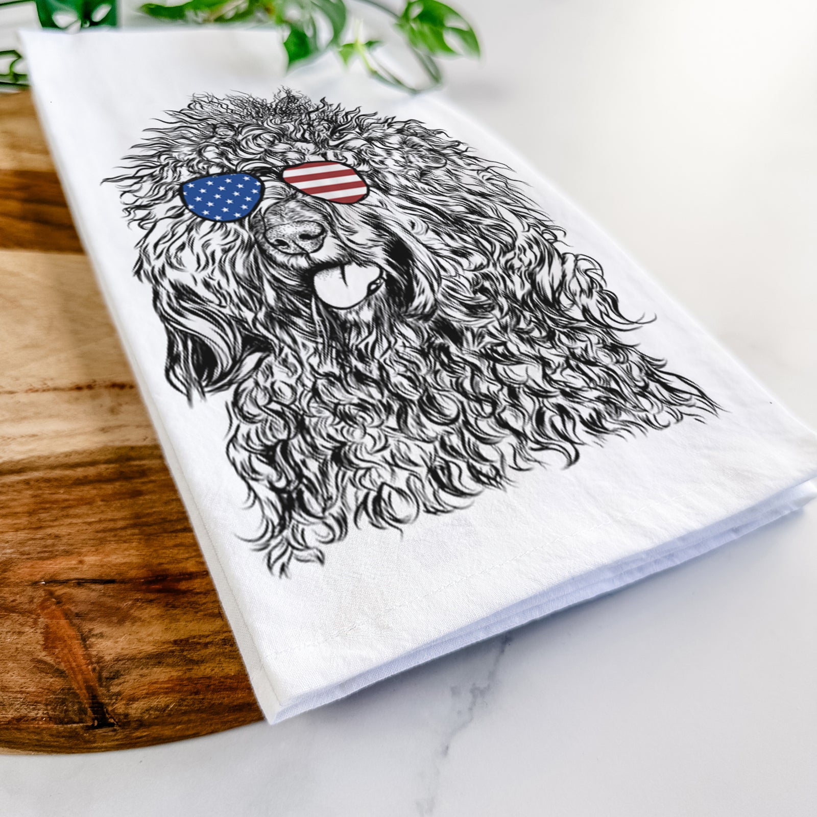 Hand-drawn sketch of Babs the Barbet wearing American flag sunglasses on a tea towel