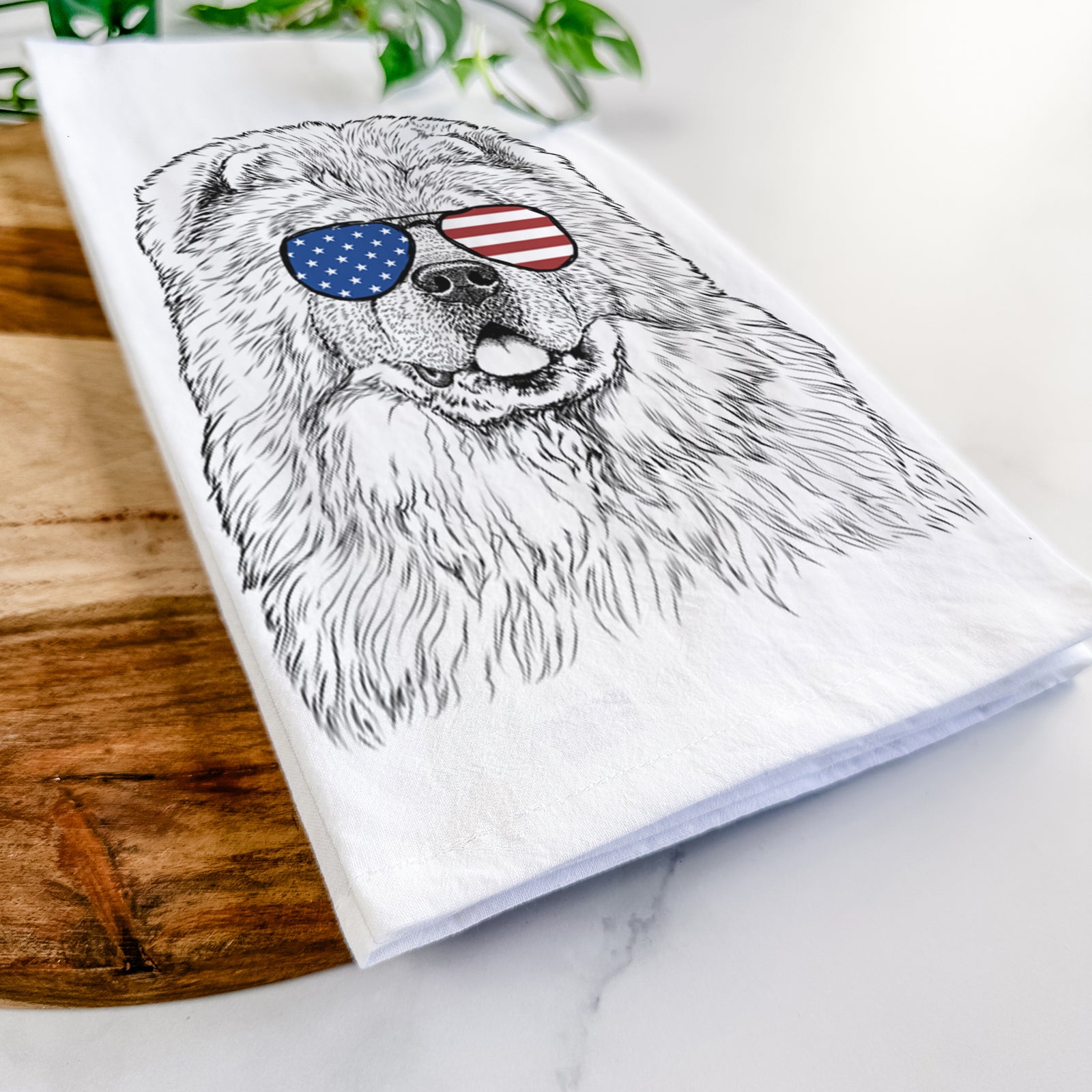 Hand-drawn sketch of Baloo the Chow Chow wearing American flag sunglasses on a tea towel
