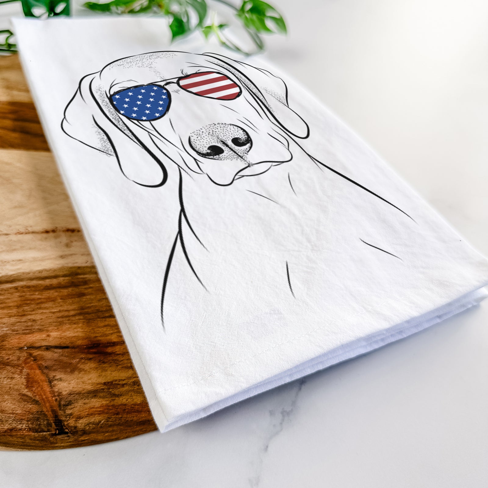 Hand-drawn sketch of Benelli the Vizsla wearing American flag sunglasses on a tea towel