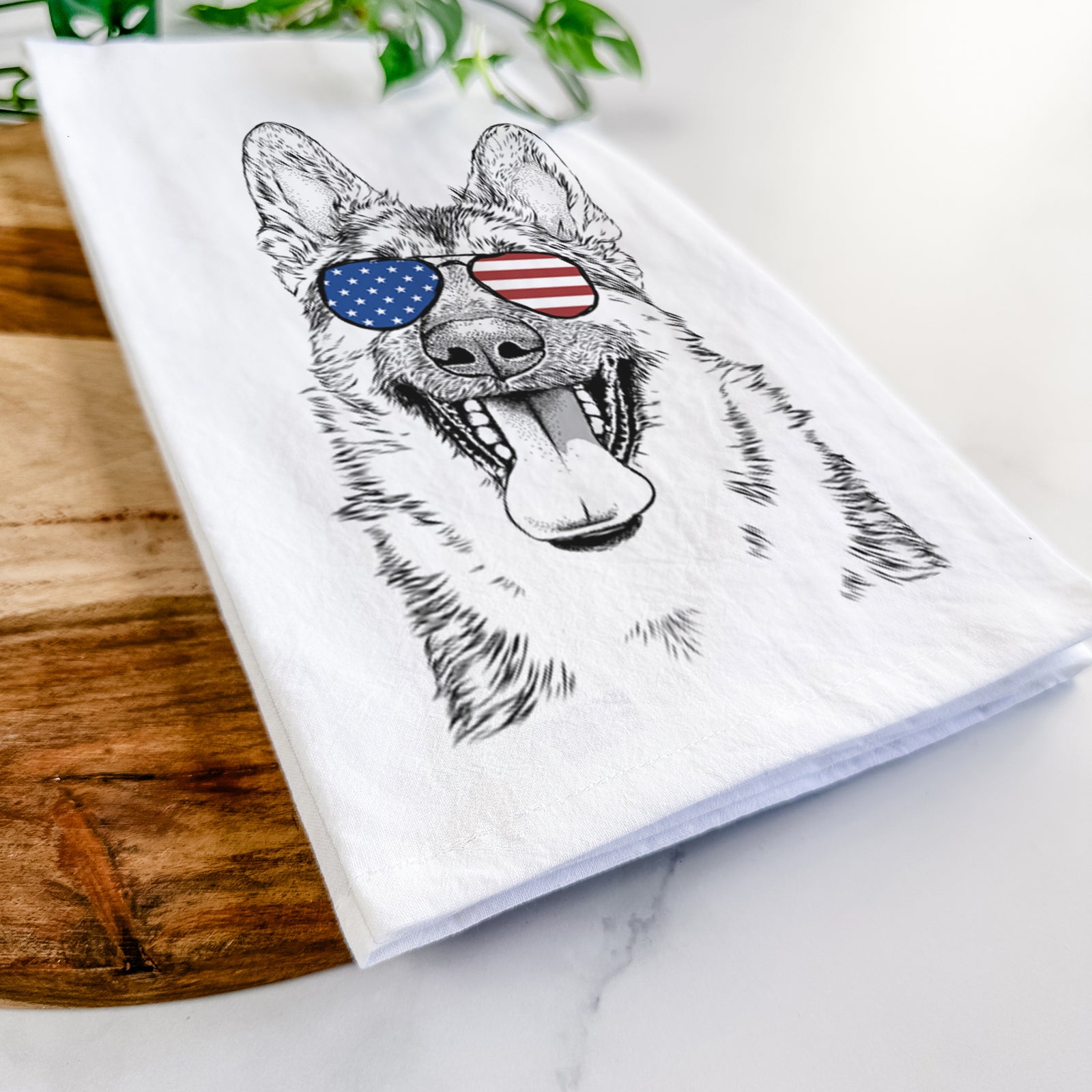 Hand-drawn sketch of Benson the German Shepherd wearing American flag sunglasses on a tea towel