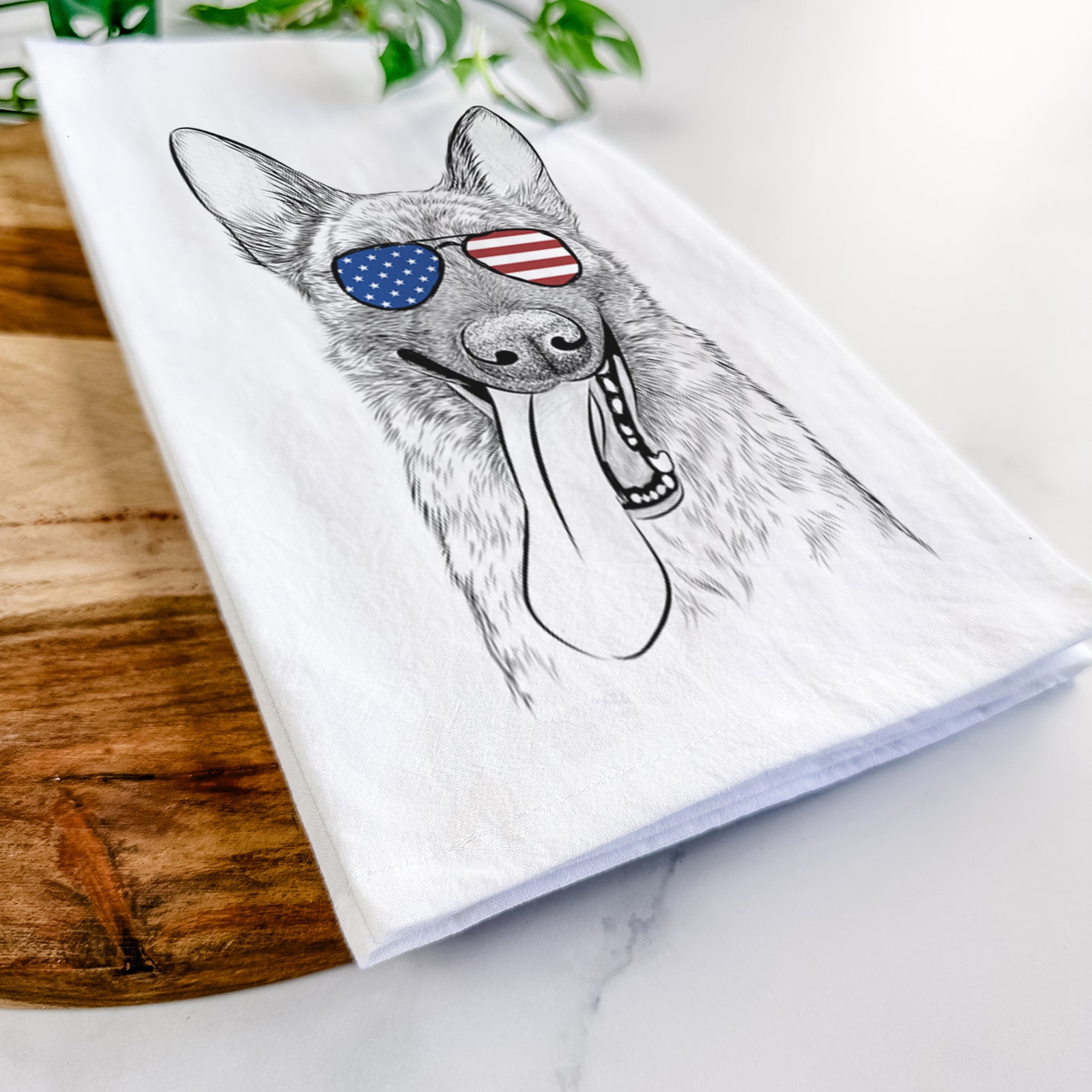 Hand-drawn sketch of Bessa the Dutch Shepherd wearing American flag sunglasses on a tea towel