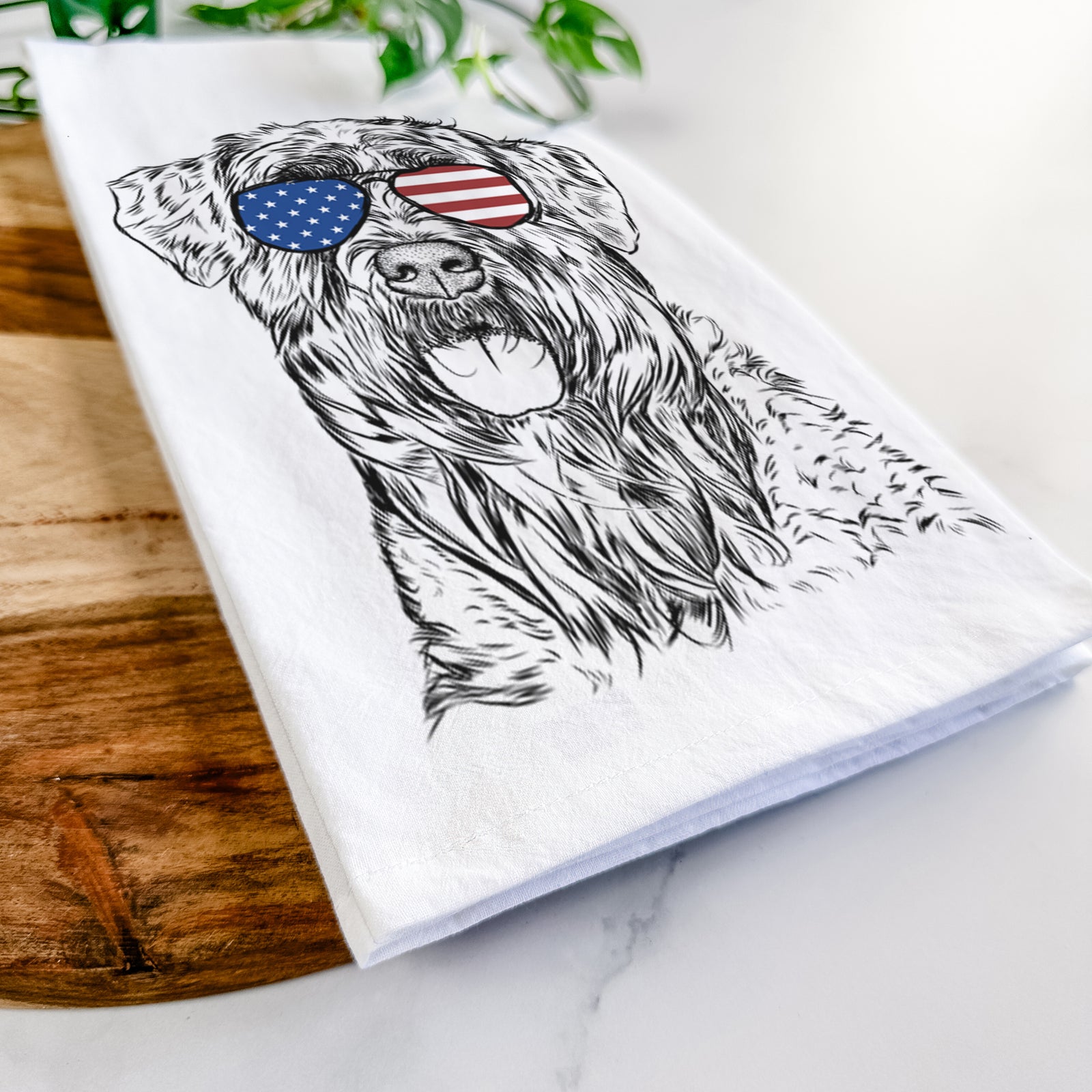 Hand-drawn sketch of Bonnie the Bouvier Des Flandres wearing American flag sunglasses on a tea towel