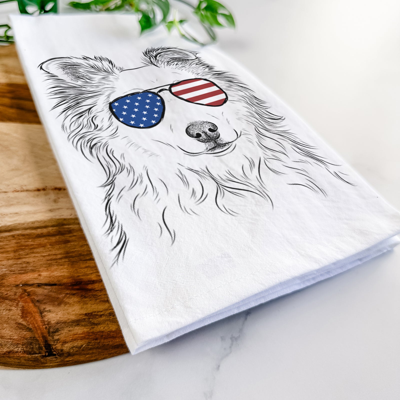 Hand-drawn sketch of Bonsai the Mixed Breed wearing American flag sunglasses on a tea towel